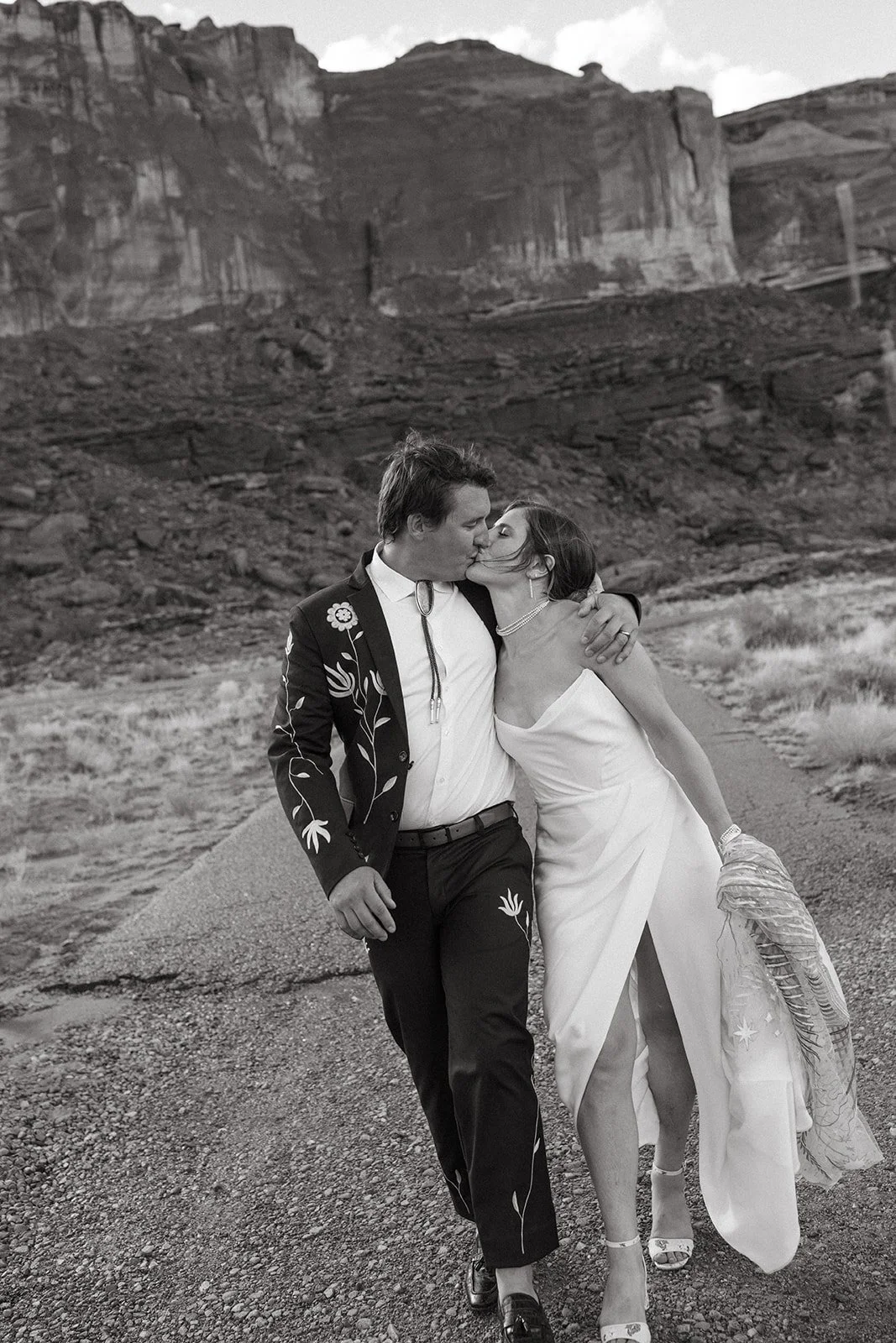 couple kisses at moab elopement