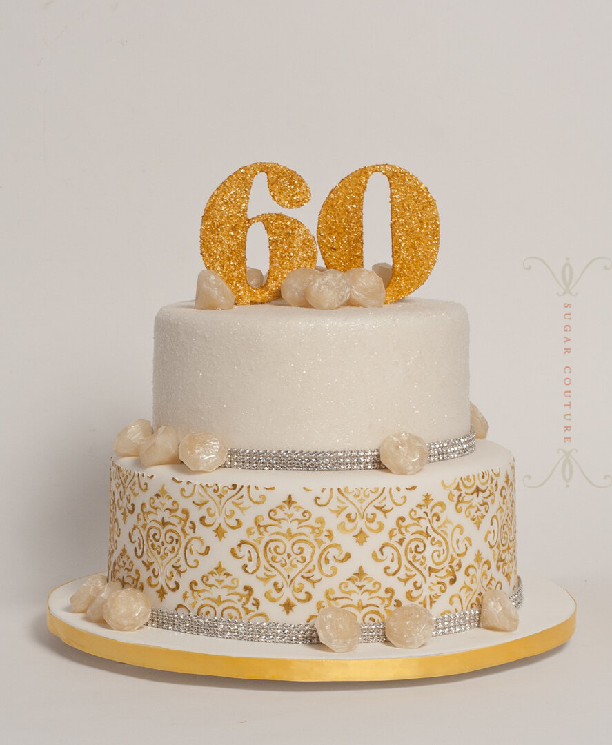 Premium Photo | The holiday cake is decorated with golden balls gold  glitters and black macaroons men's birthday cake 60 years close up