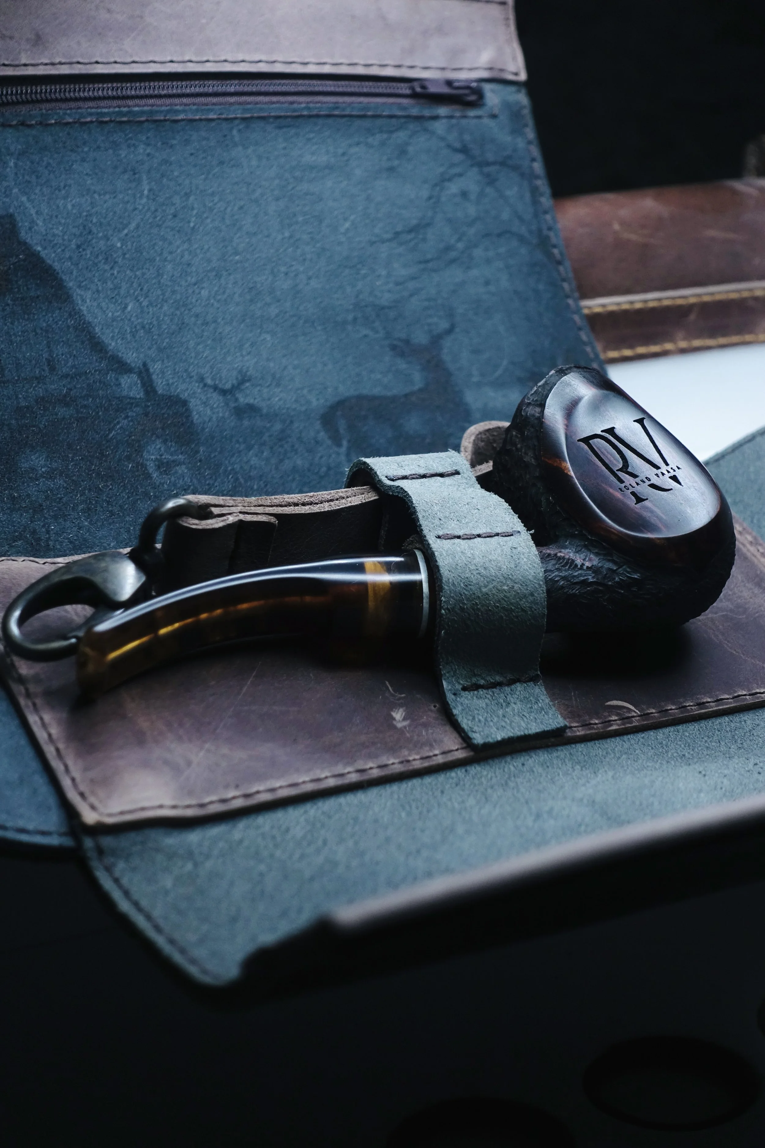 Wooden tobacco pipe on leather pouch