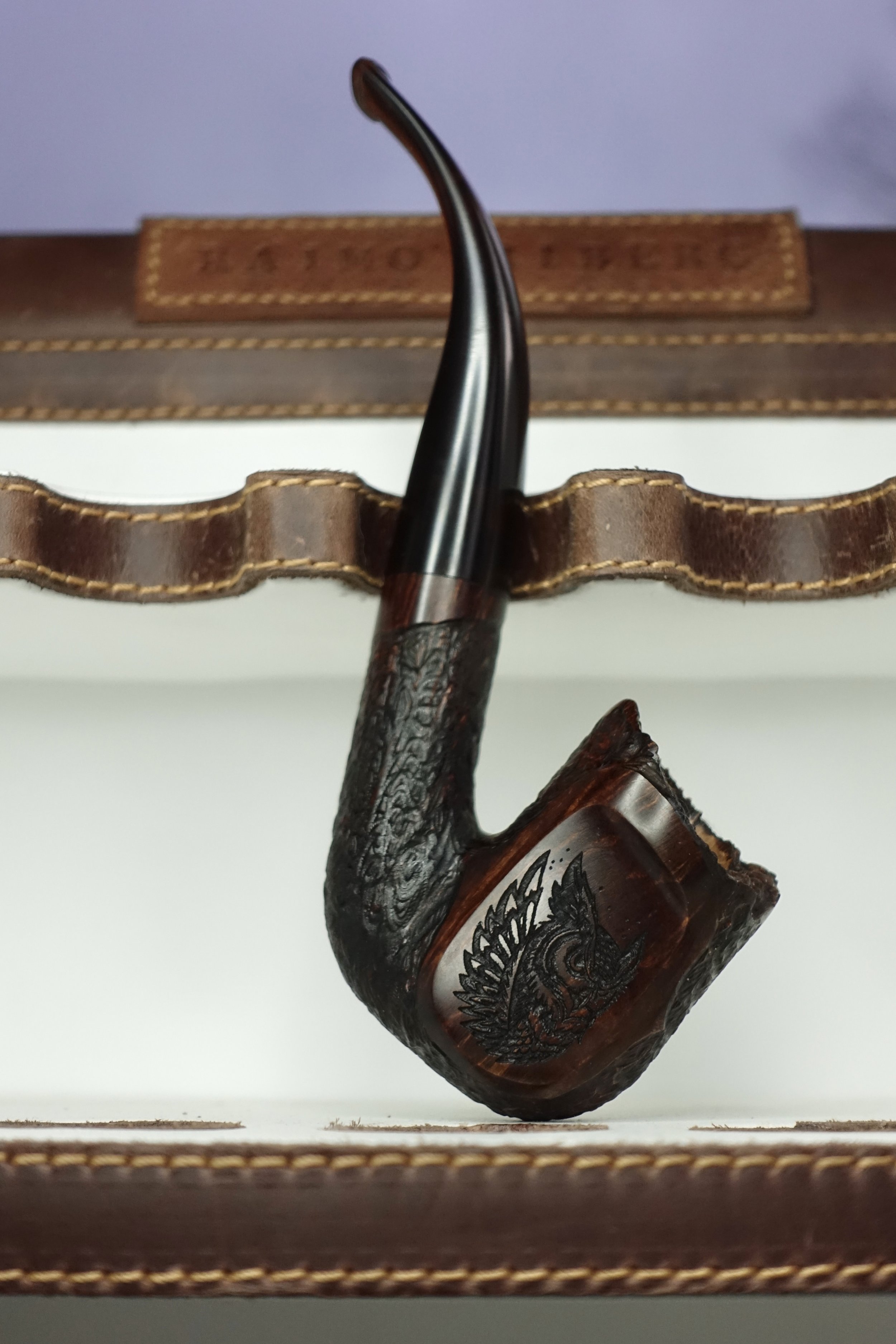 Carved smoking pipe with leather case