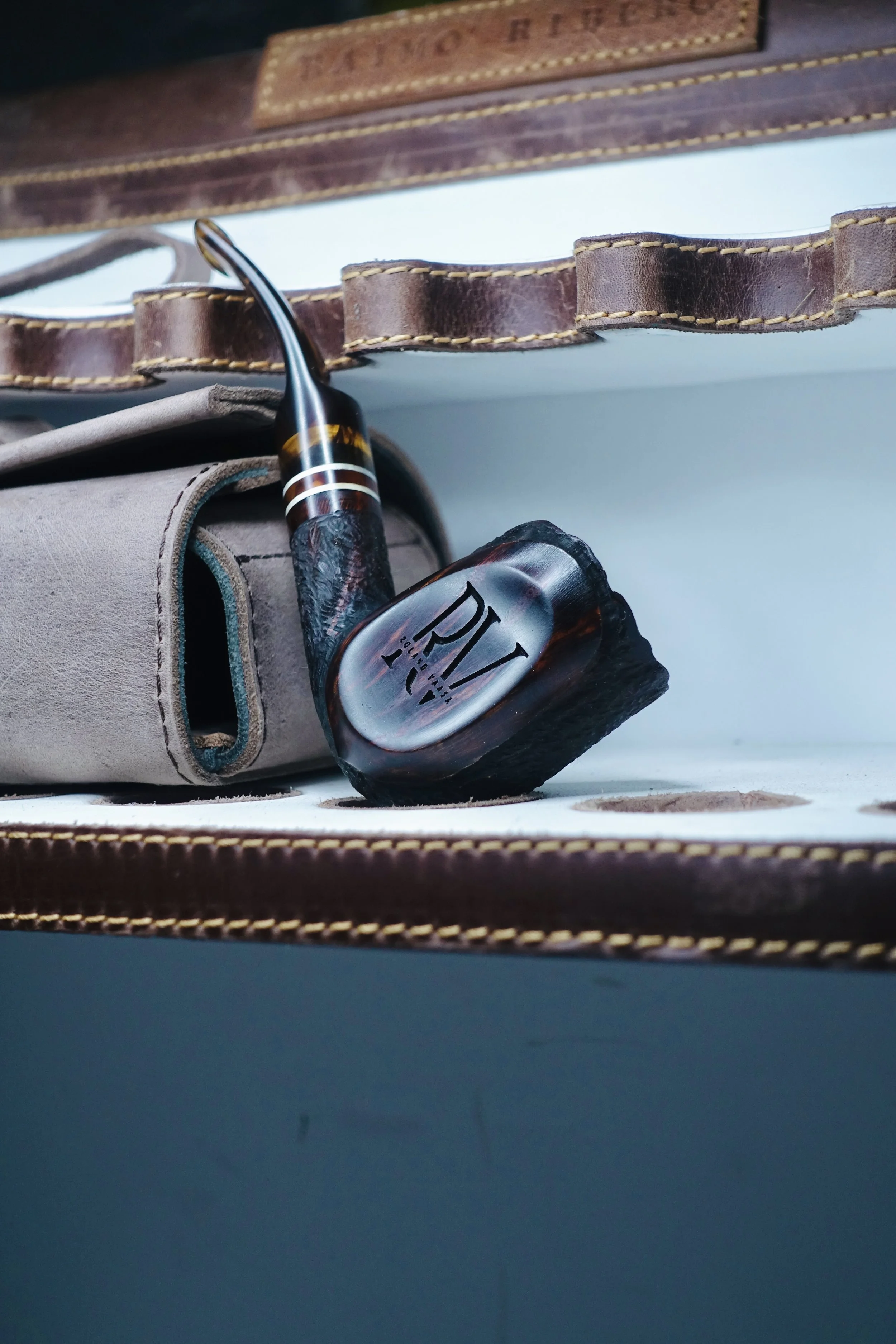 close-up of a tobacco pipe with leather case