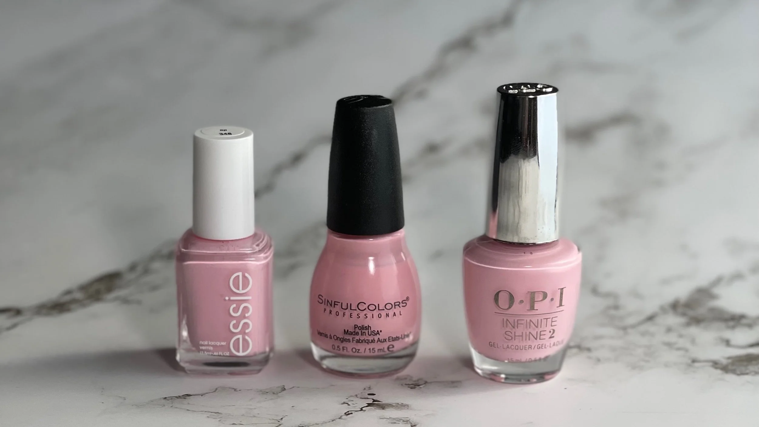 essie fiji, Sinful Colors Pink Smart and OPI Infinite Shine Mod About You bottles on grey marble background