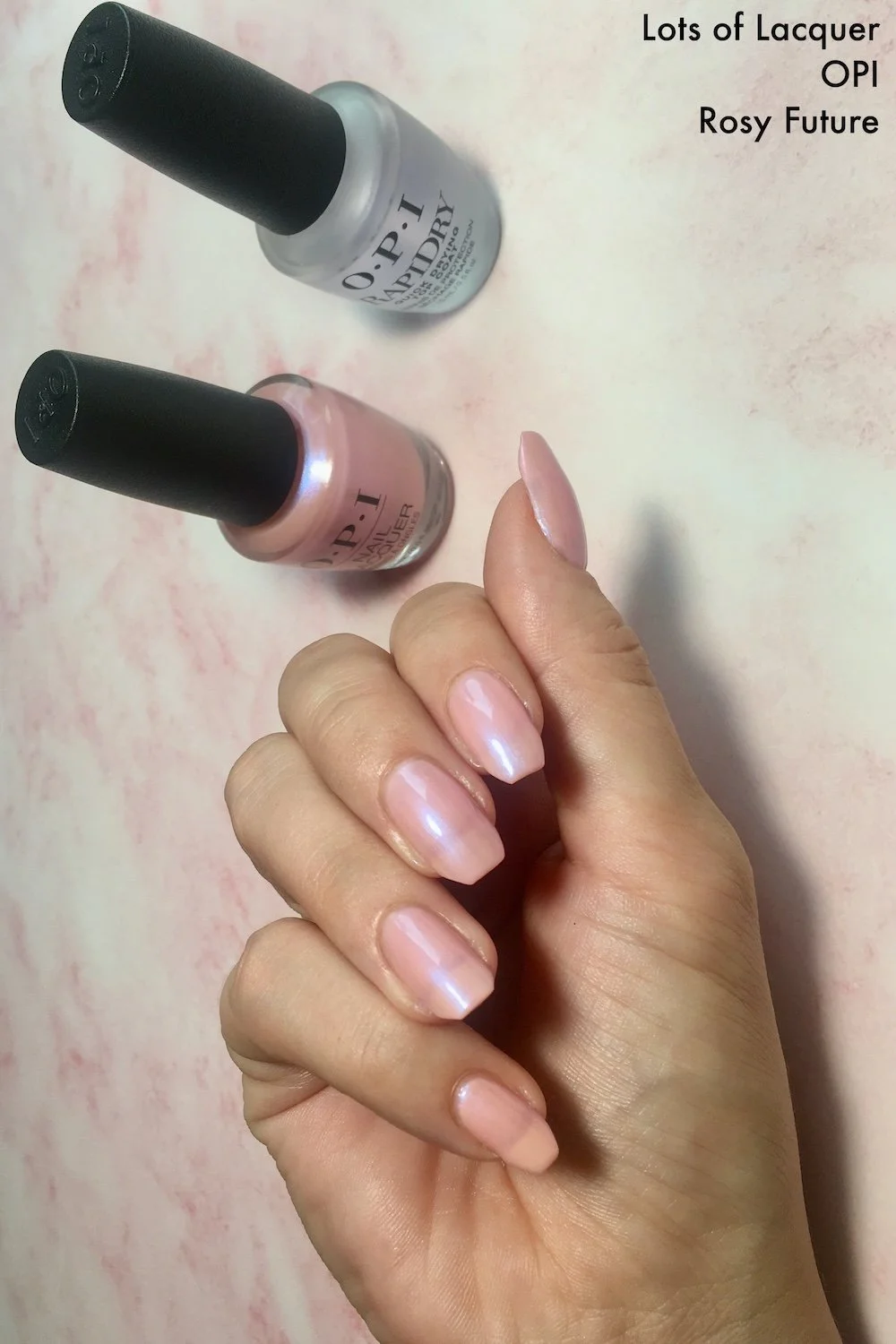 OPI Rosy Future swatch with polish bottles top