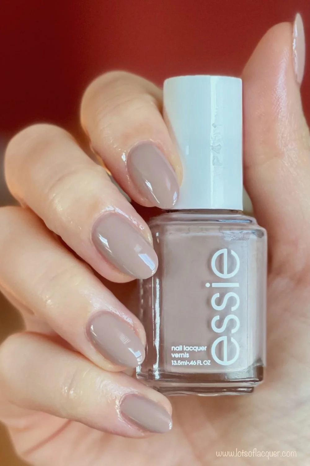 essie wild nude swatch holding bottle