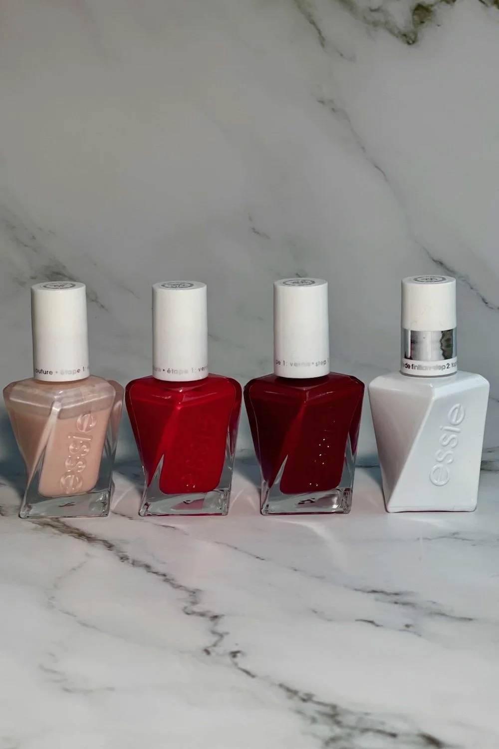 Photo of four essie gel couture nail polish bottles