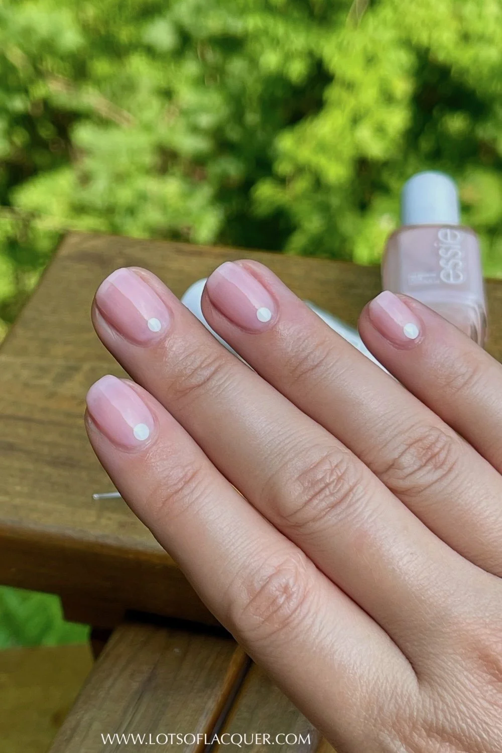 white dot nails with wood in background