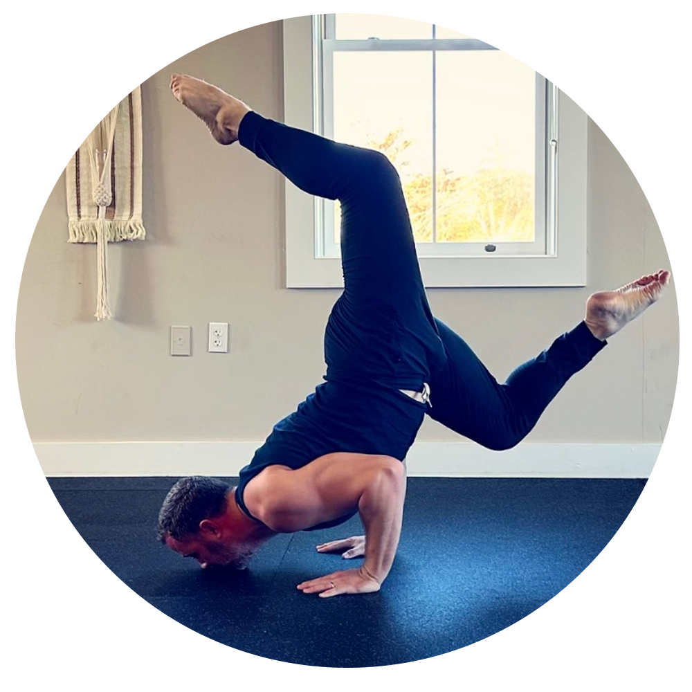 Person performing a yoga pose with one leg extended in an indoor setting.
