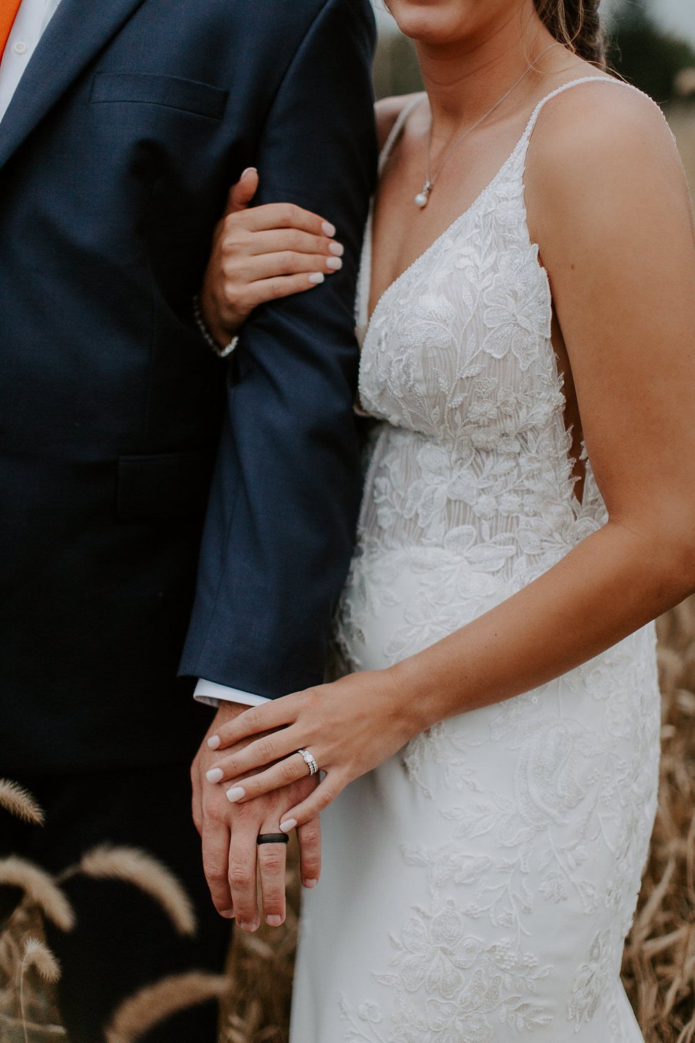 Couple holds hands in field at Lancaster, Pennsylvania wedding 