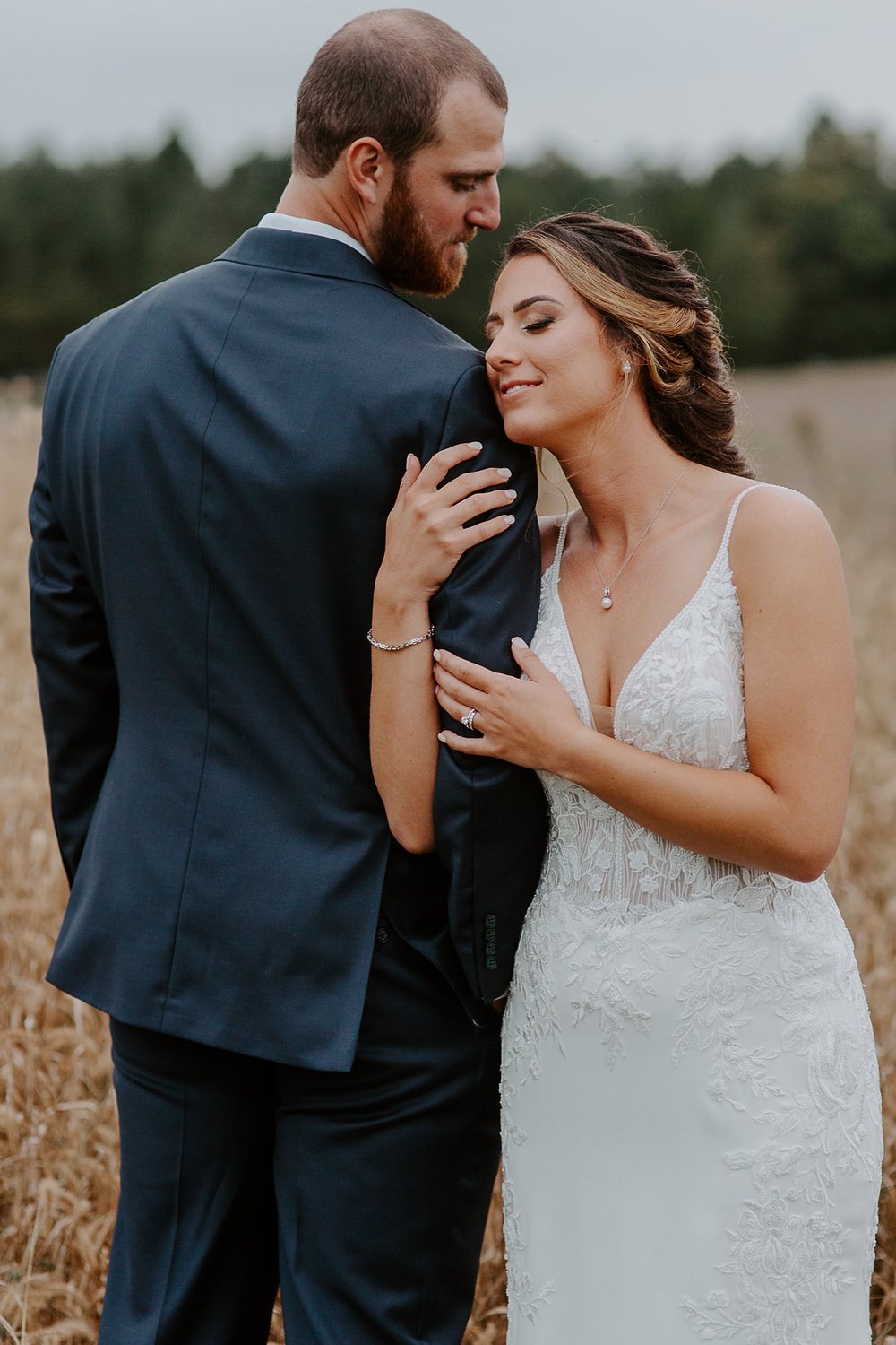 Couple embraces in field at Lancaster, Pennsylvania wedding
