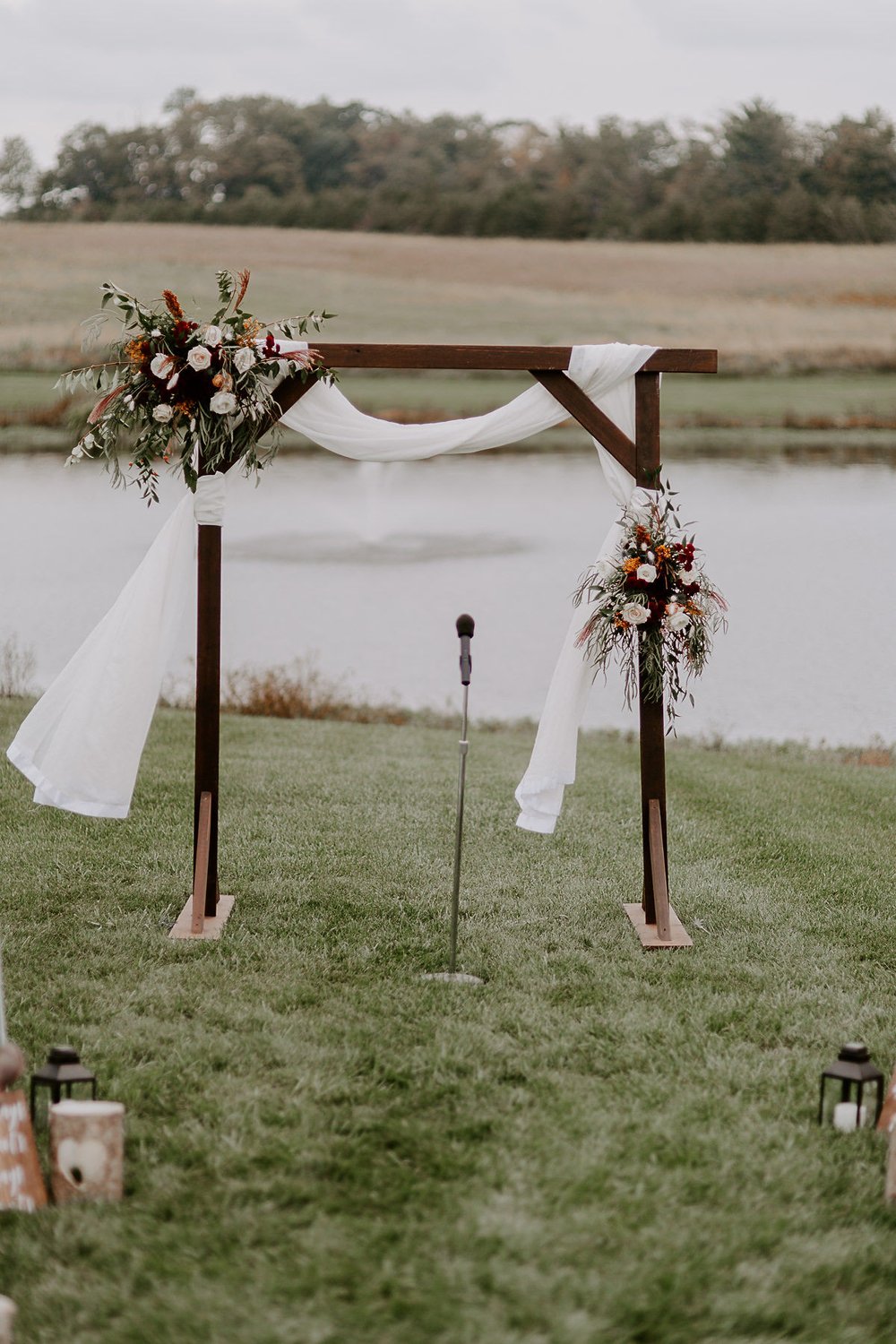 Wedding arch decorated with florals at outdoor wedding