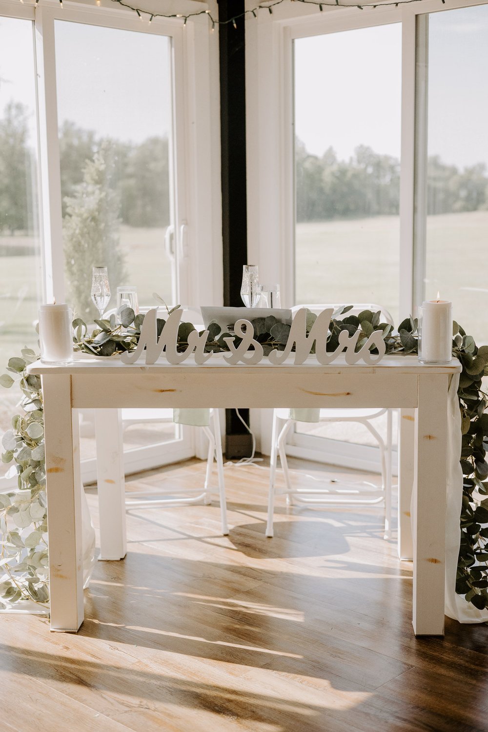 Couple's table decorated with florals and lettering