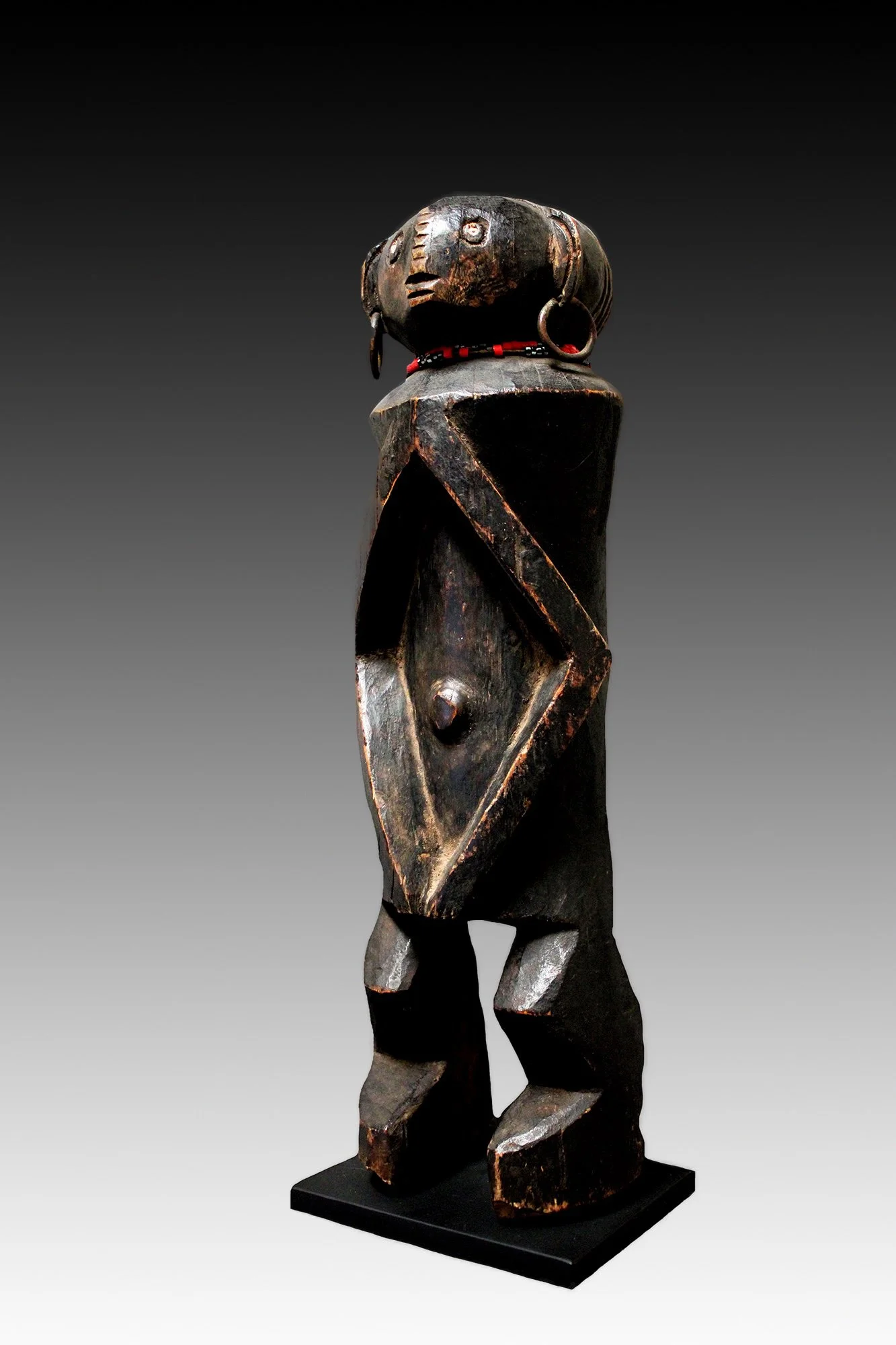 Rare Banda or Zande figure, with a cylindrical torso, bent arms that form a lozenge and short bent legs.  www.gallerytribalart.com
