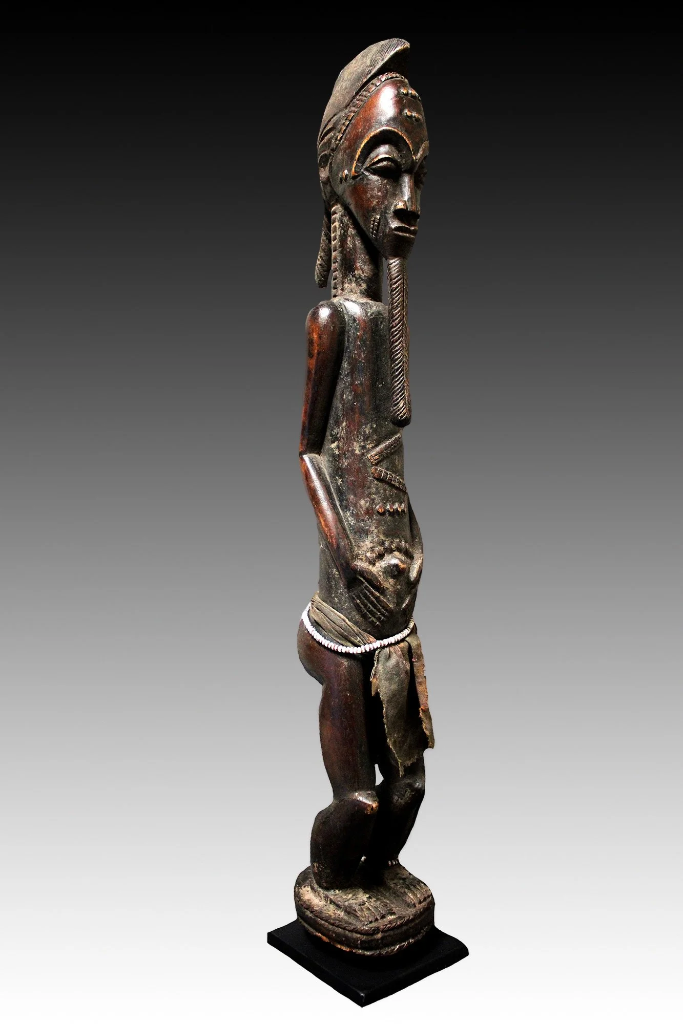 Baule figure, with beard, scarification and hands resting on abdomen.  www.intriguegallery.com