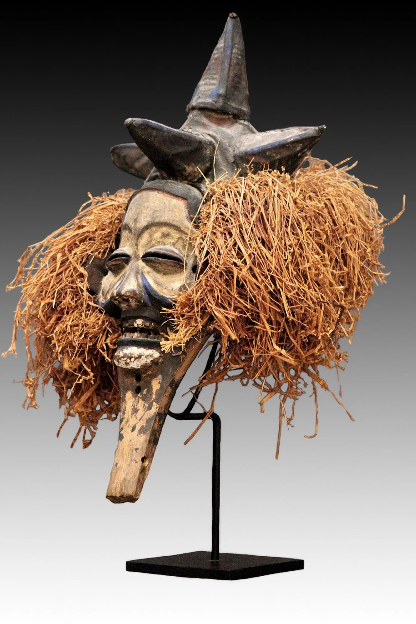 Yaka mask from the Congo, has an expressive polychrome face with slit eyes and open mouth barring teeth.  www.intriguegallery.com