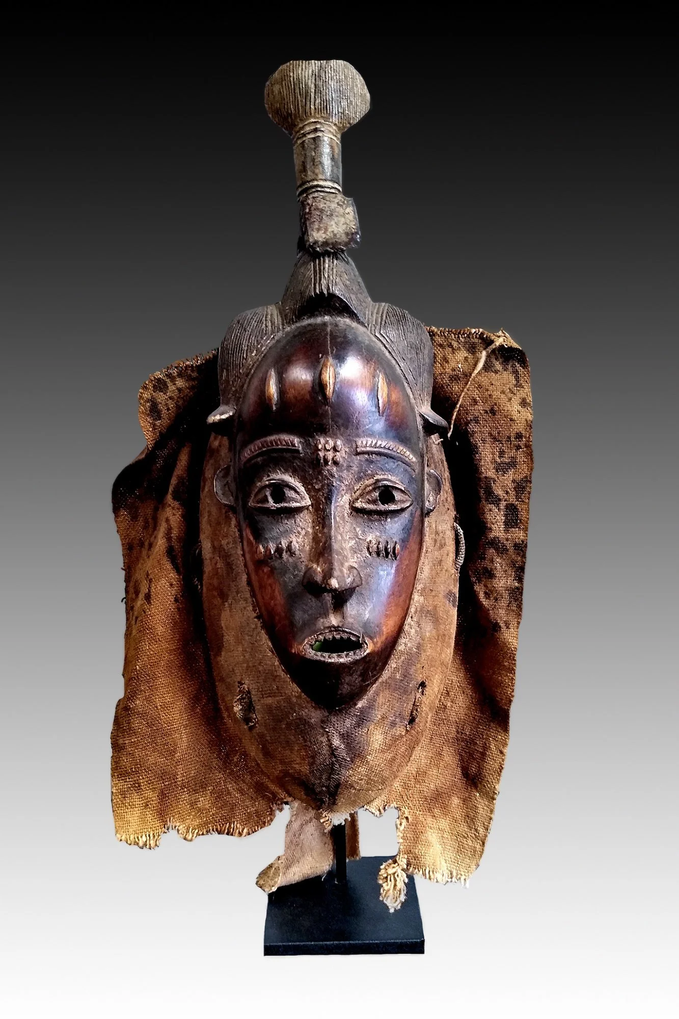 Guro mask has a narrow face, high domed forehead, scarification and filed teeth.  www.intriguegallery.com