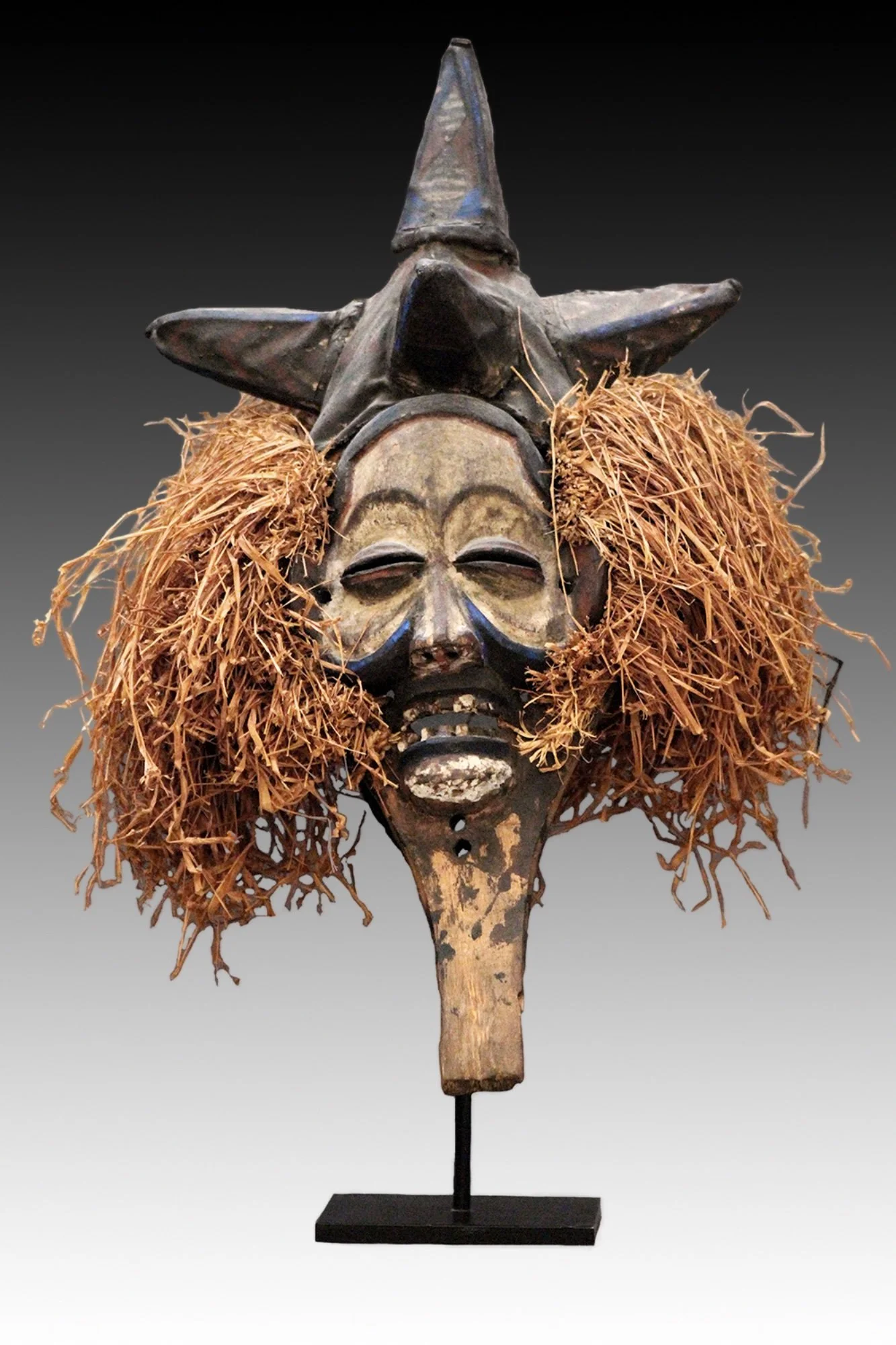 Yaka mask, the headdress is woven fiber with five raised cone forms.  www.intriguegallery.com