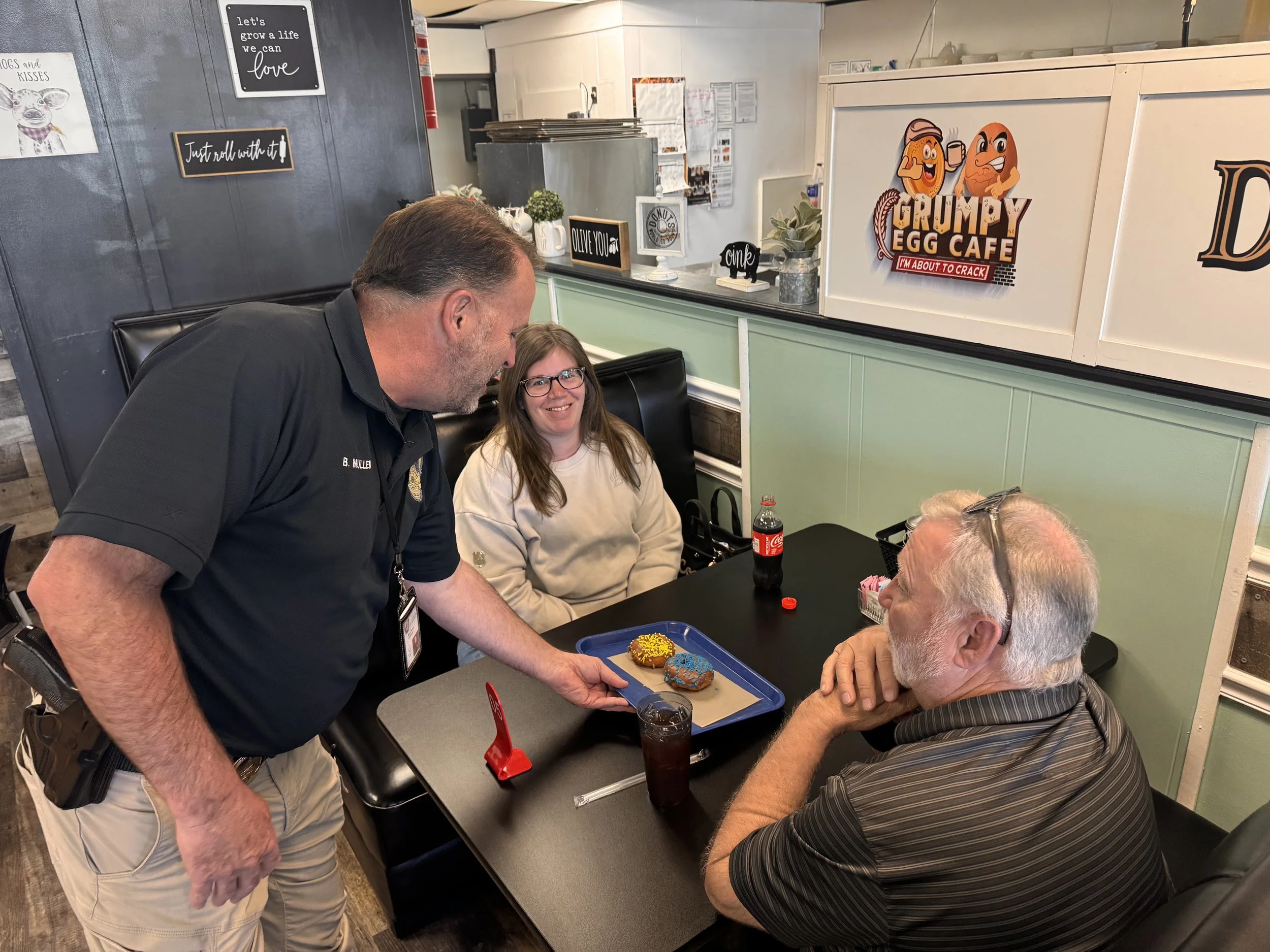 police officer serving donuts to residents