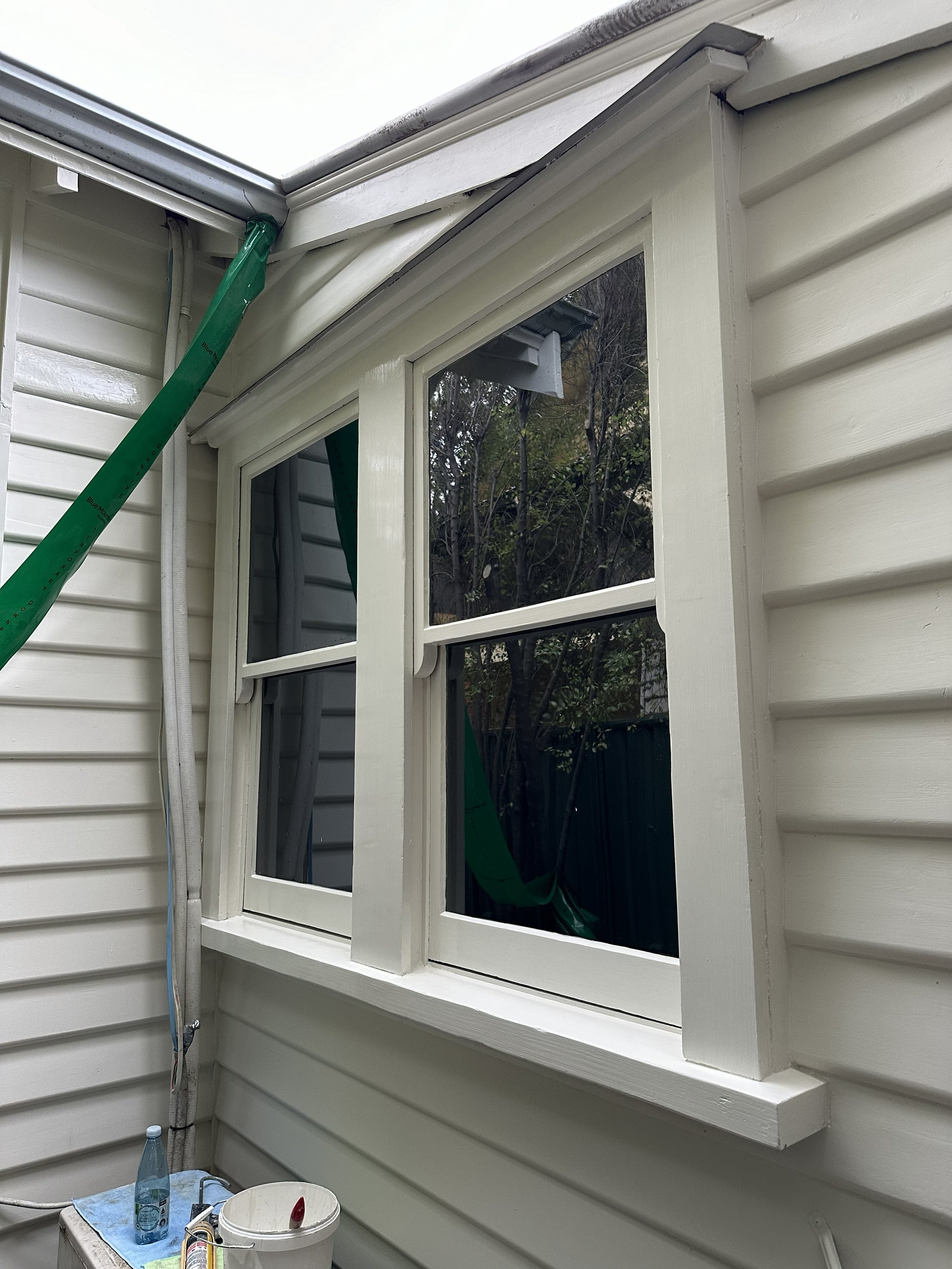 After photo showing restored sash window with smooth gloss finish and repaired timber.