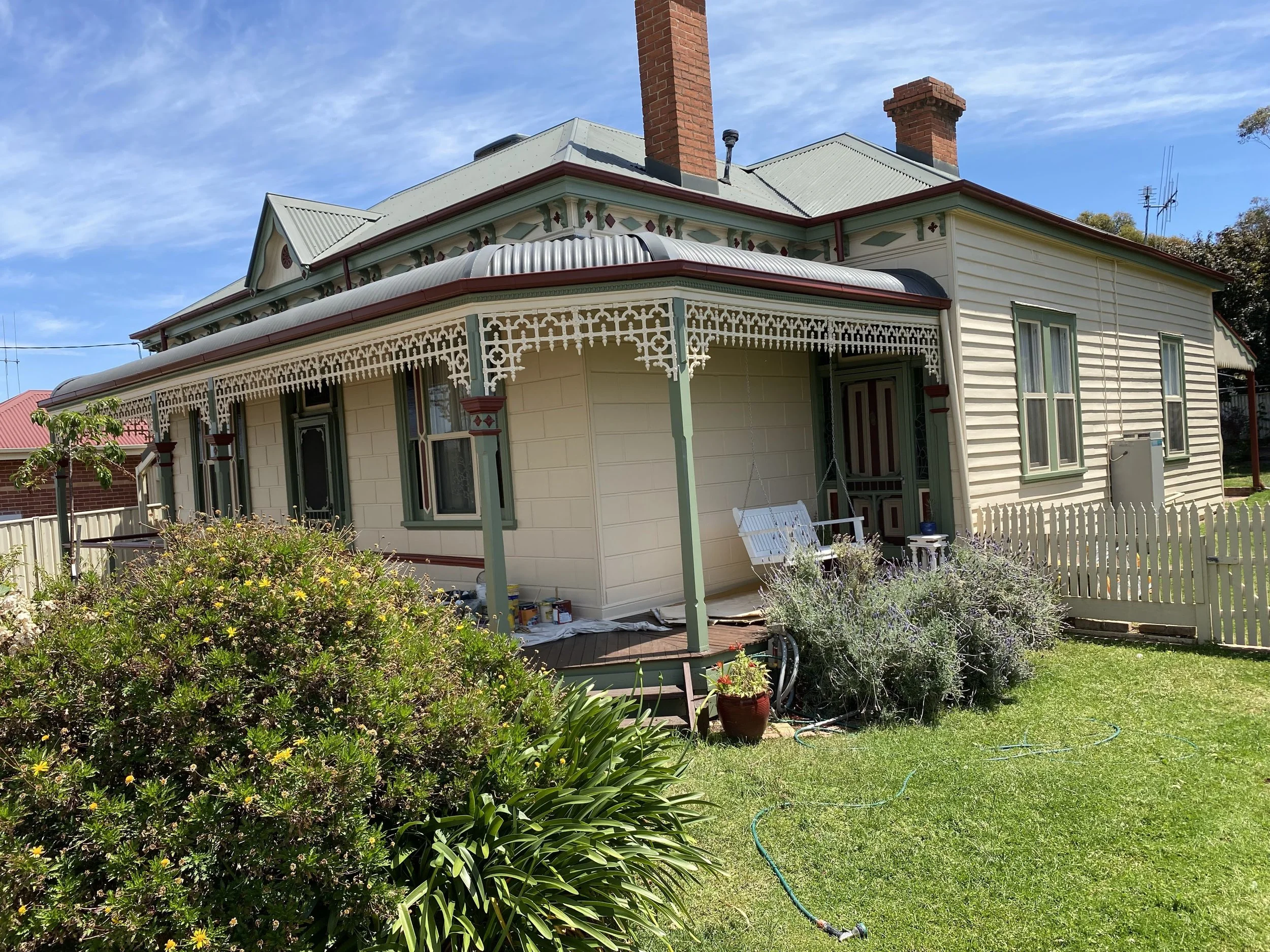 Detailed exterior repaint highlighting repaired timber boards and clean, even coverage.