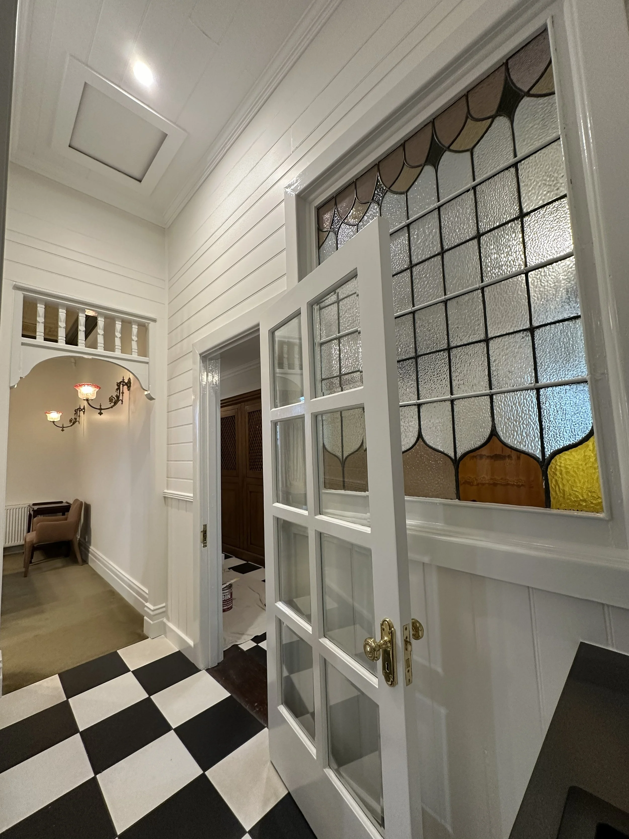 Dining room repaint featuring restored timber trims and uniform wall coverage.