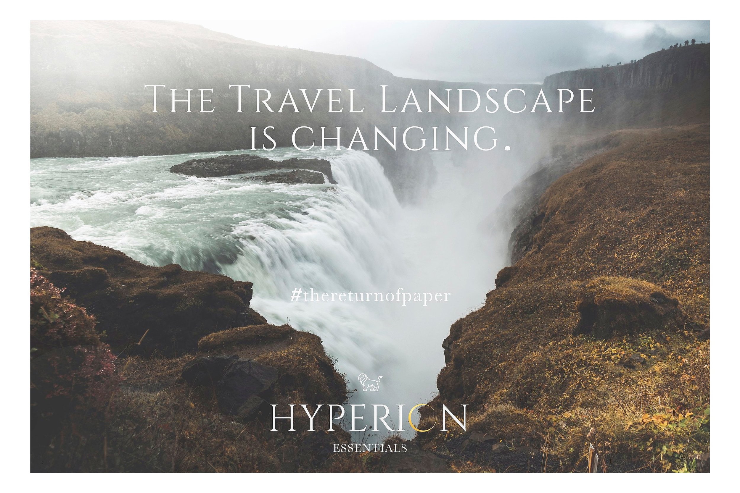 A misty waterfall in a rugged landscape with rocky cliffs and greenery, overcast sky with some visitors visible on the cliffs in the background.