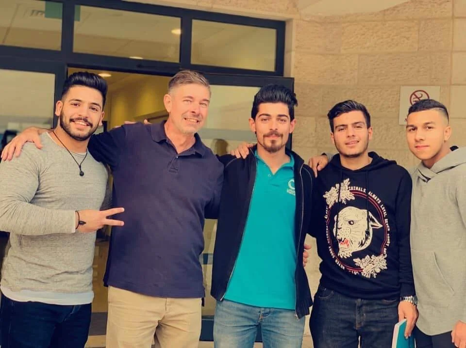 Reverand Jon Brown and students at Dar Al-Kalima University in Bethlehem, volunteering through the nonprofit Volunteers in Global Service