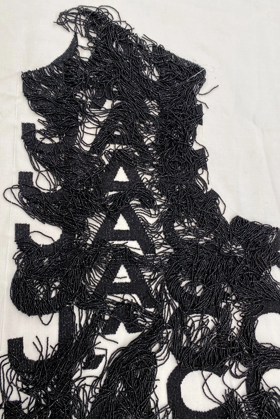 MJ_F21_LOGOBEADEDFRINGE_DETAIL2_RES150.jpg