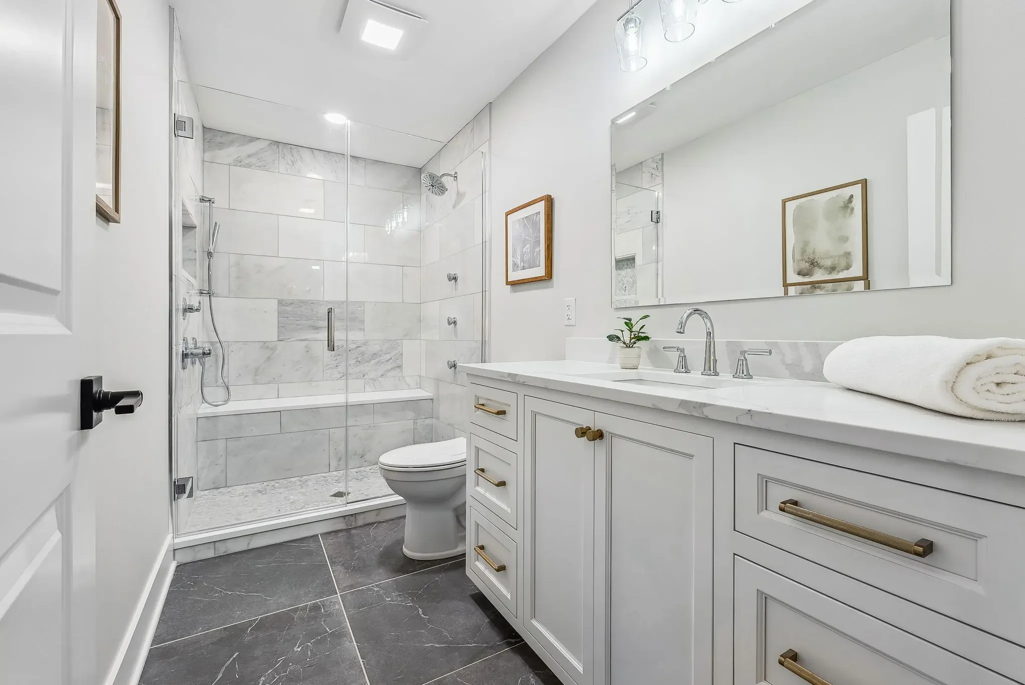 Modern bathroom with walk-in shower and brass fixtures in Upper Arlington Ohio