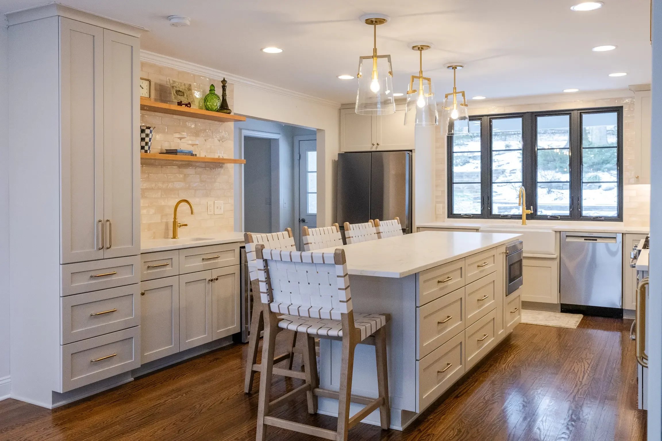 pper Arlington kitchen remodel with beige cabinetry, brass fixtures, open shelving, and center island by Elevate Remodeling Columbus Ohio