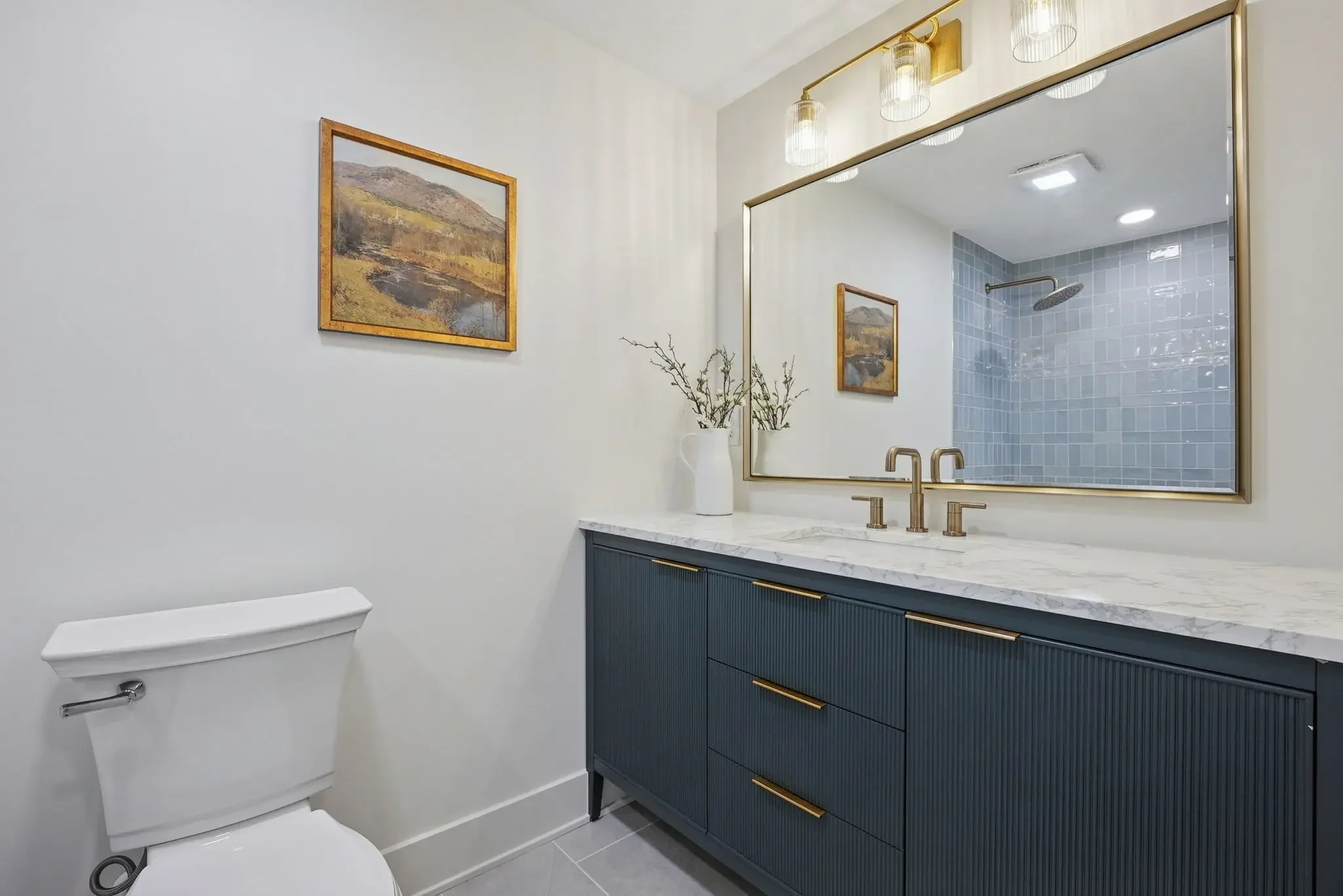 Upper Arlington Ohio bathroom remodel with custom vanity, brass fixtures, marble countertop, and walk-in tile shower