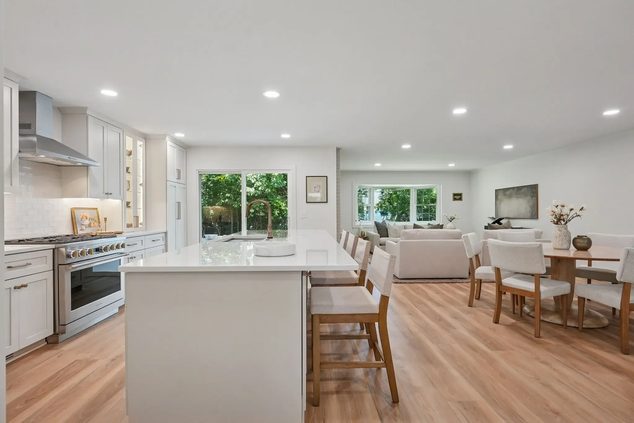 Open-concept kitchen remodel in Columbus Ohio with large island, custom cabinetry, hardwood flooring, and connected living space