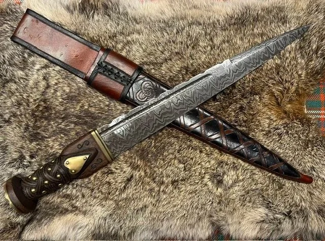 109. A damascus dirk I forged for my friends wedding. The bride and groom cut the cake with it.
