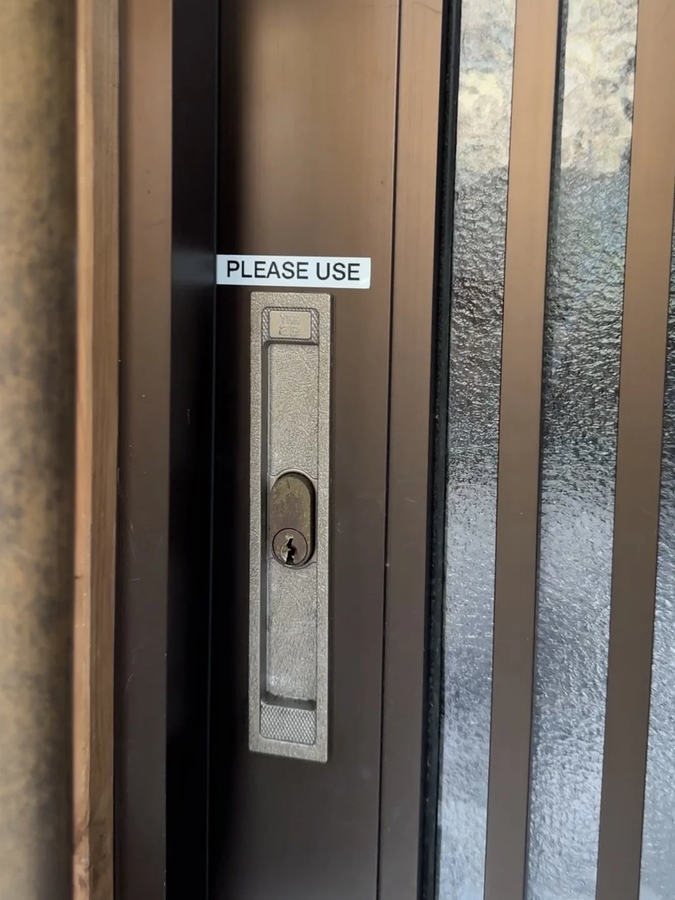 Please unlock the door using the lock on the left.