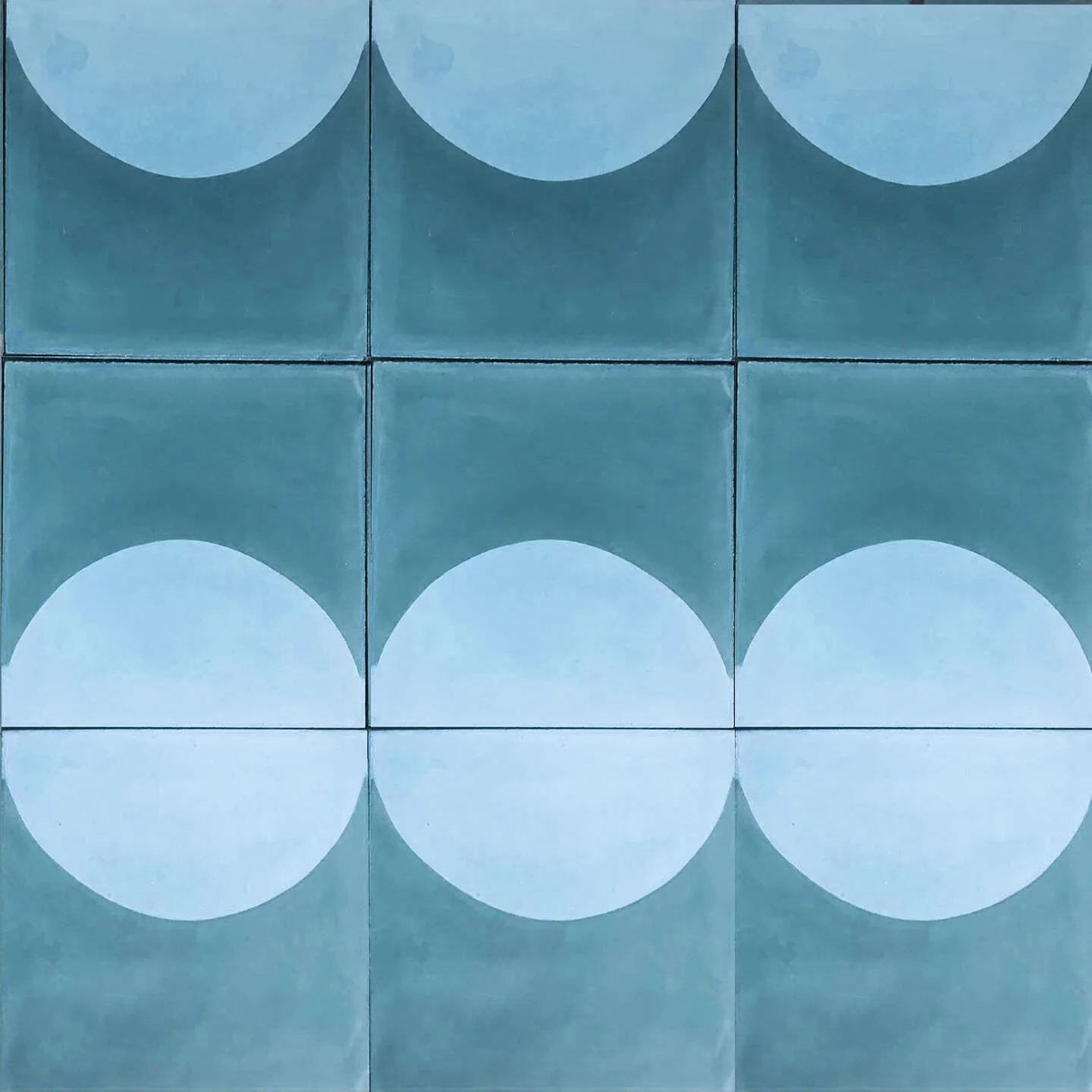 A grid of nine tiles, each with a blue background and a white semi-circle in the center, forming a pattern.