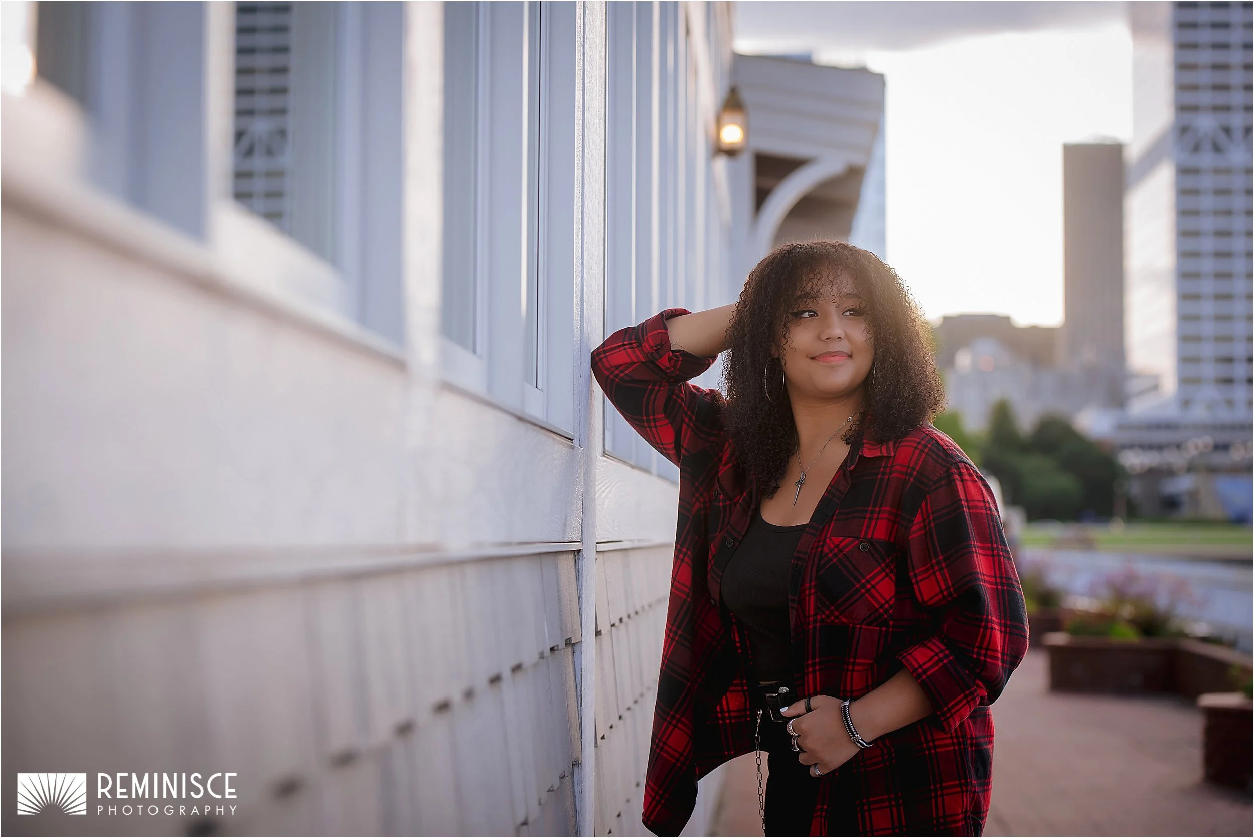 04-girl-leaning-white-building-by-water-downtown.JPG