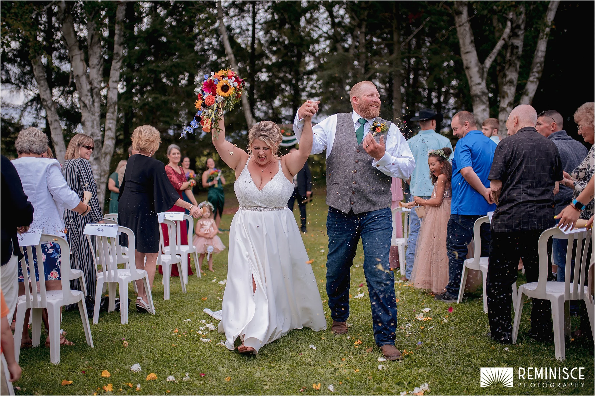 13-bride-groom-walking-down-aisle-flower-petals-thrown-on-them.JPG