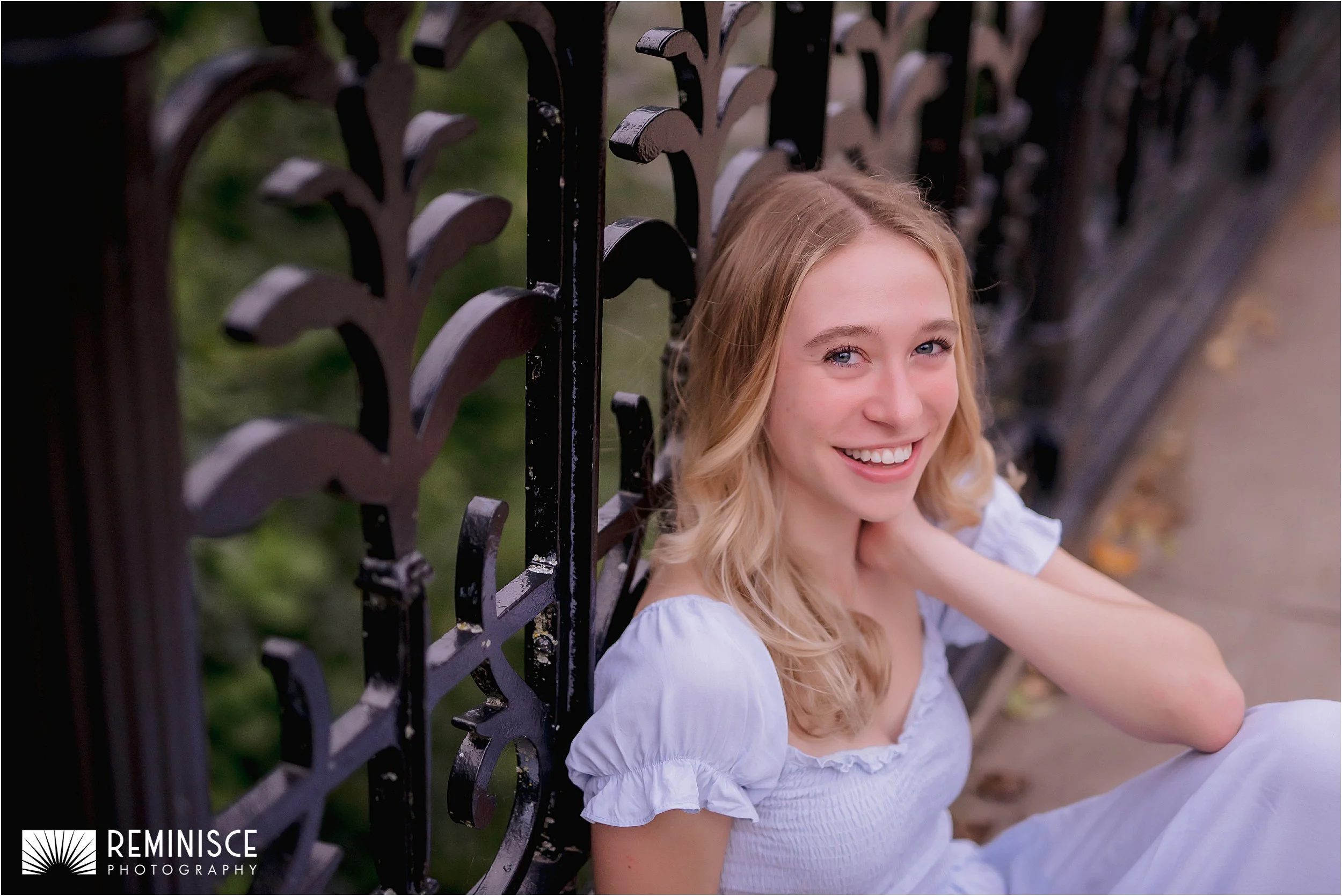 02-senior-girl-seated-back-leaning-ornate-black-metal-rail.JPG