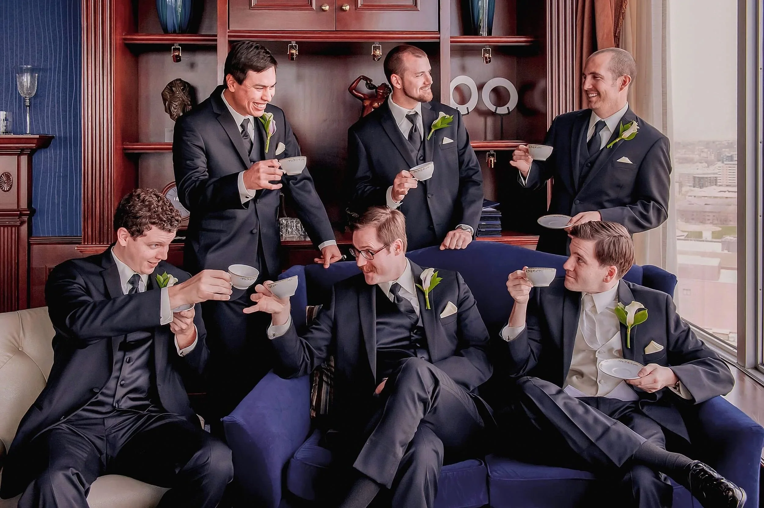 39-wedding-photography-bridal-party-fun-groomsmen-sipping-tea-pfister-hotel.jpg