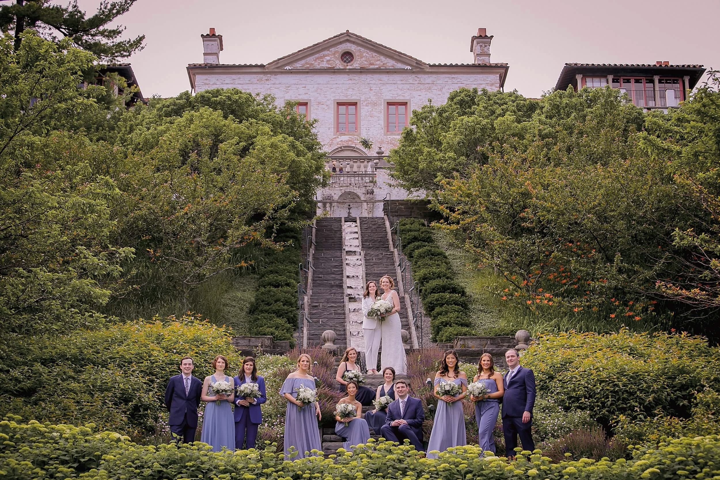 lgbtq-wedding-party-two-brides-posed-villa-terrace.png