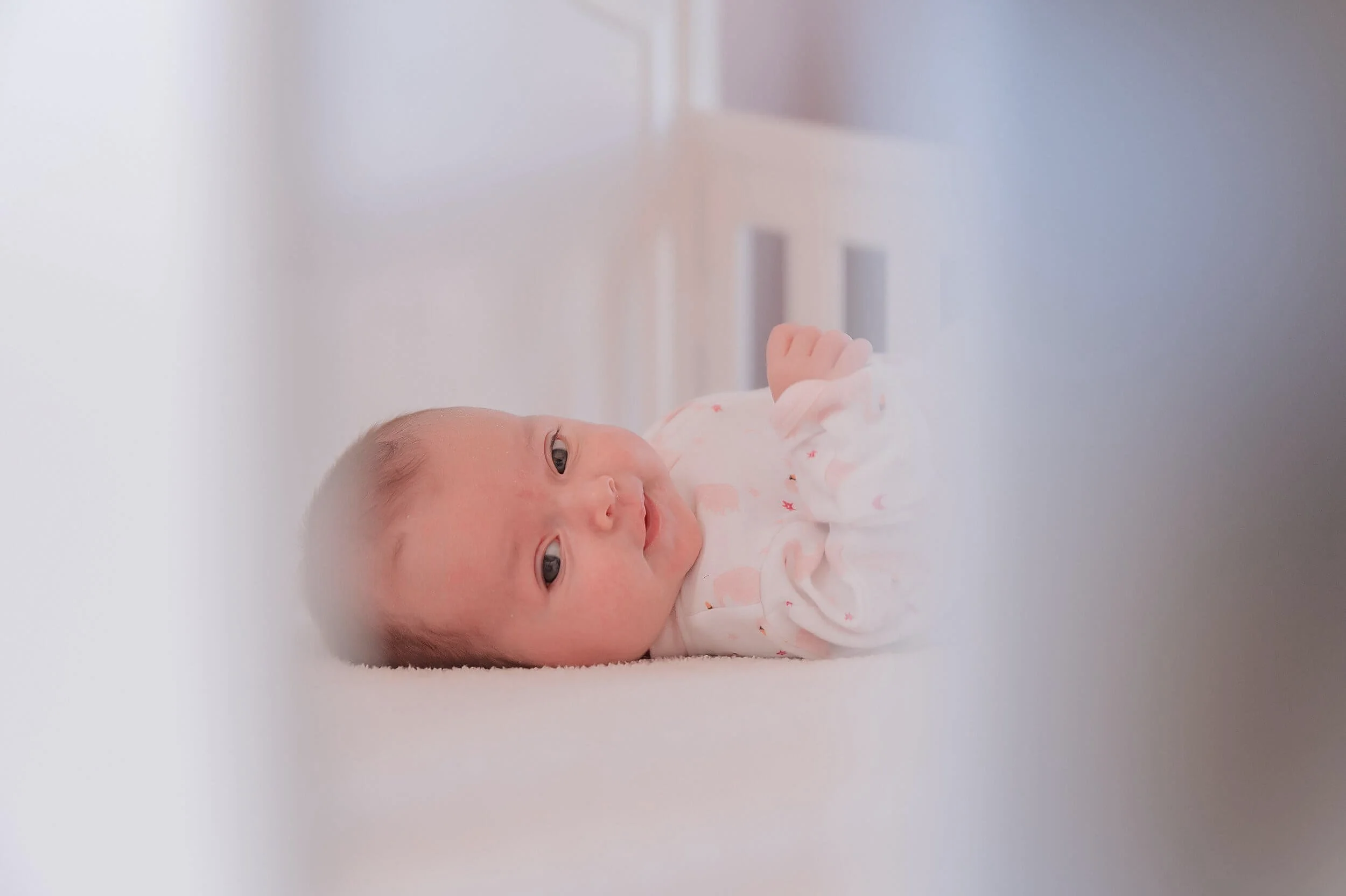 03-cozy-at-home-newborn-photos-baby-in-crib.png