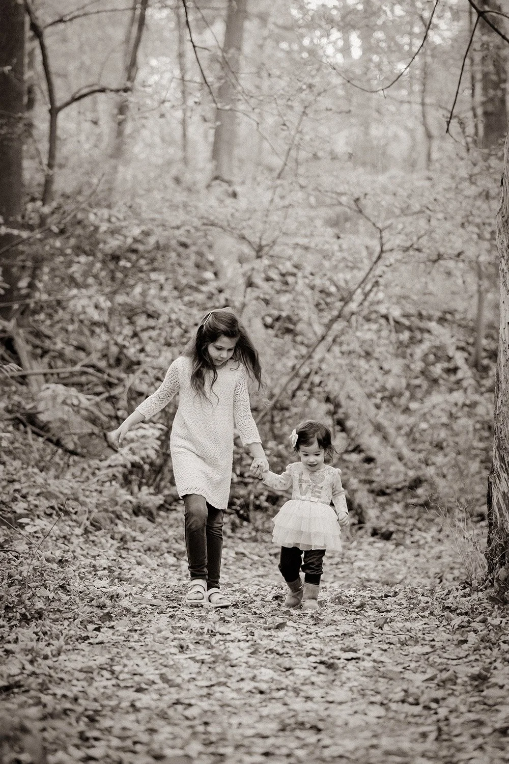 Candid family photography session in a wooded setting captured by a Milwaukee family photographer at Grant Park's Seven Bridges