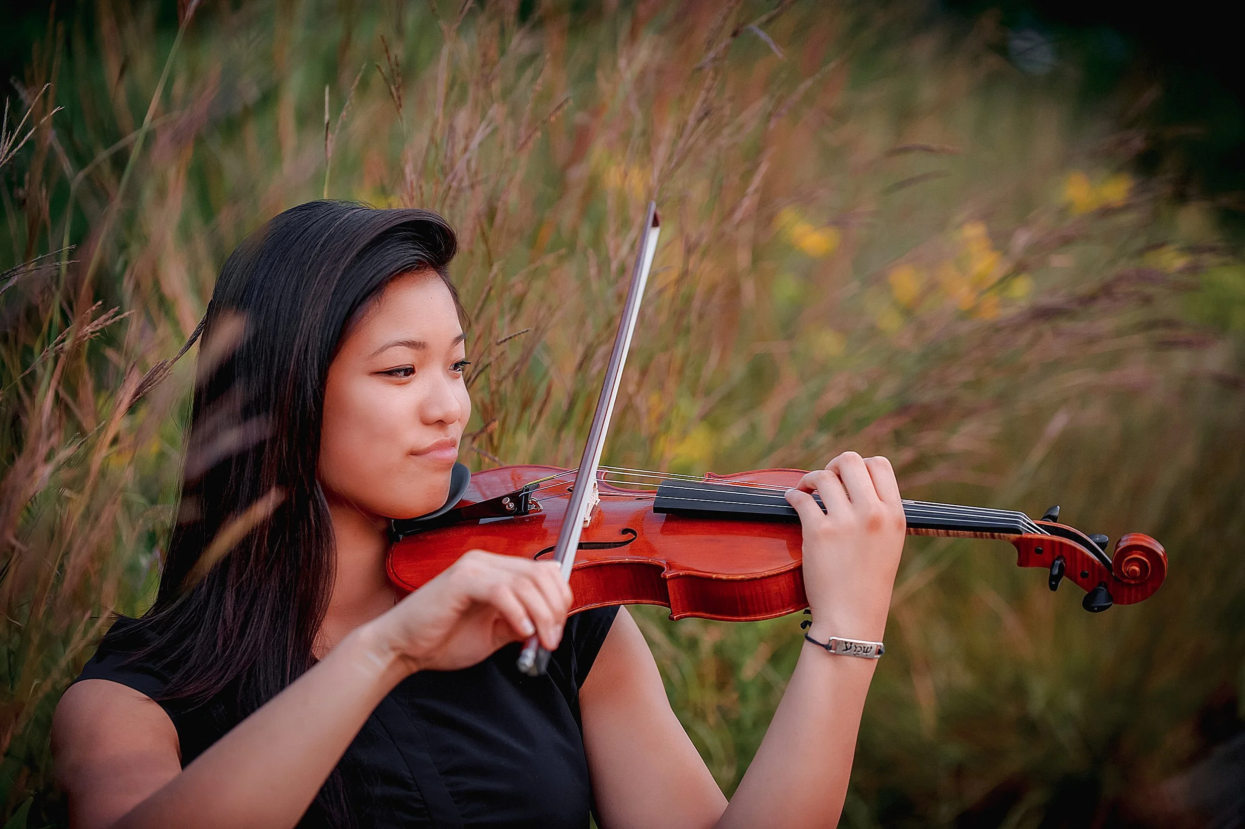 senior-girl-playing-violin-seated-tall-grasses.JPG
