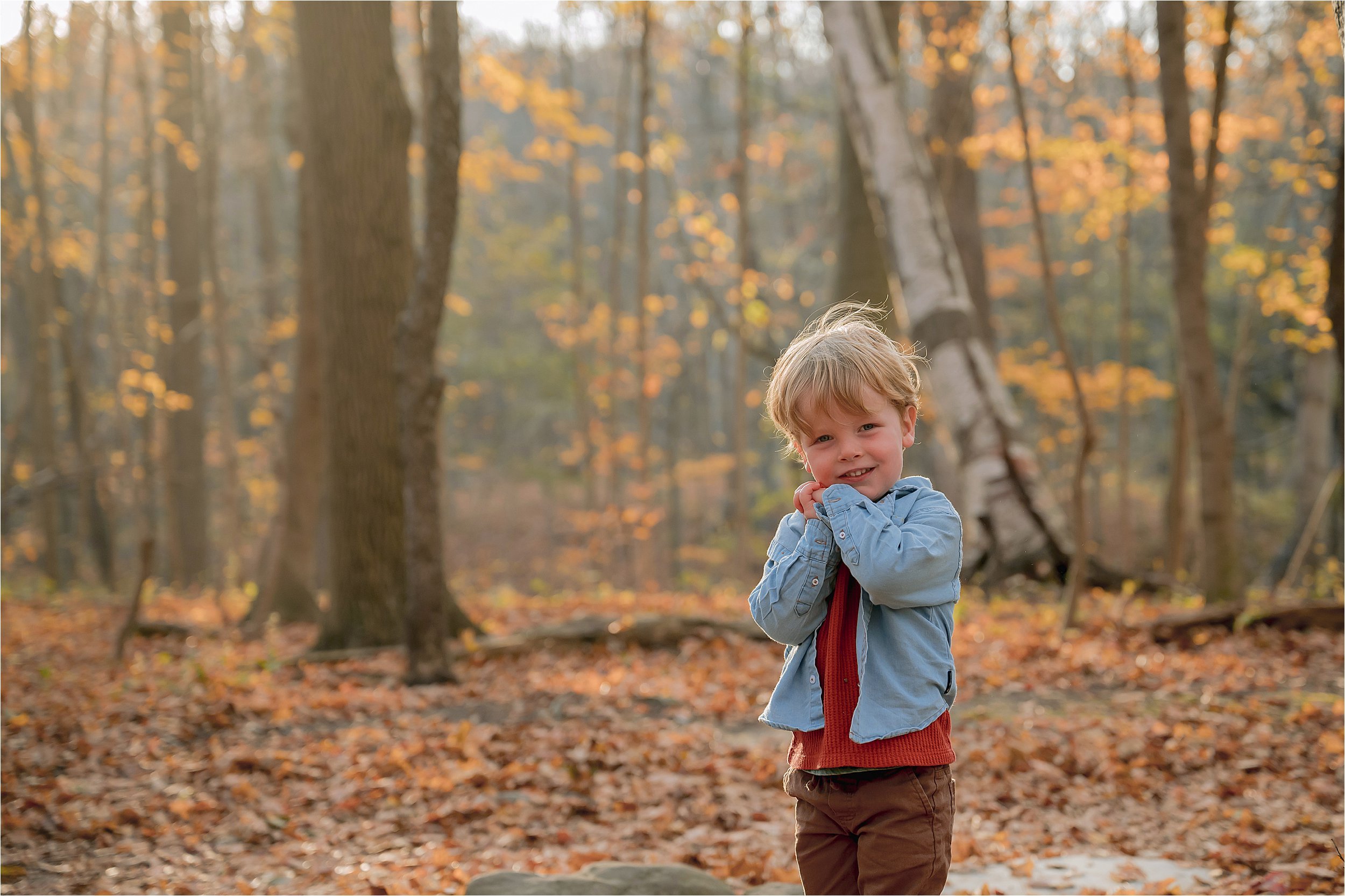Child exploring wooded trails during a fall family mini session at Seven Bridges in Grant Park Milwaukee