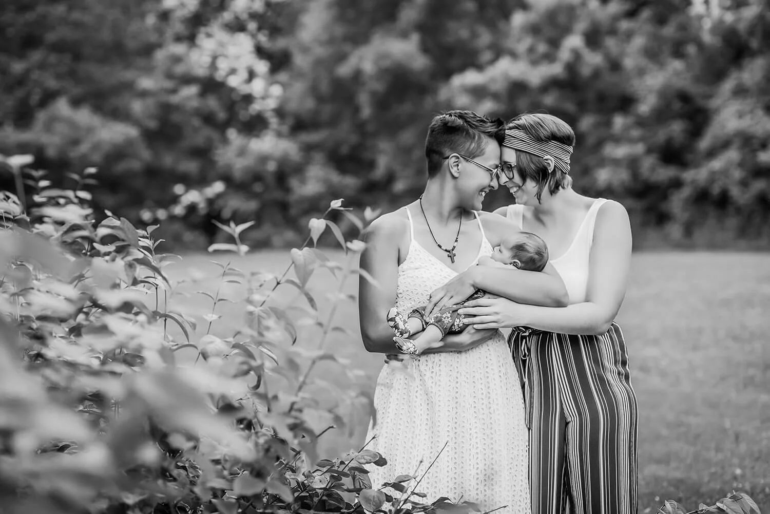 62-lgbt-newborn-photography-moms-holding-baby-outside-park.JPG