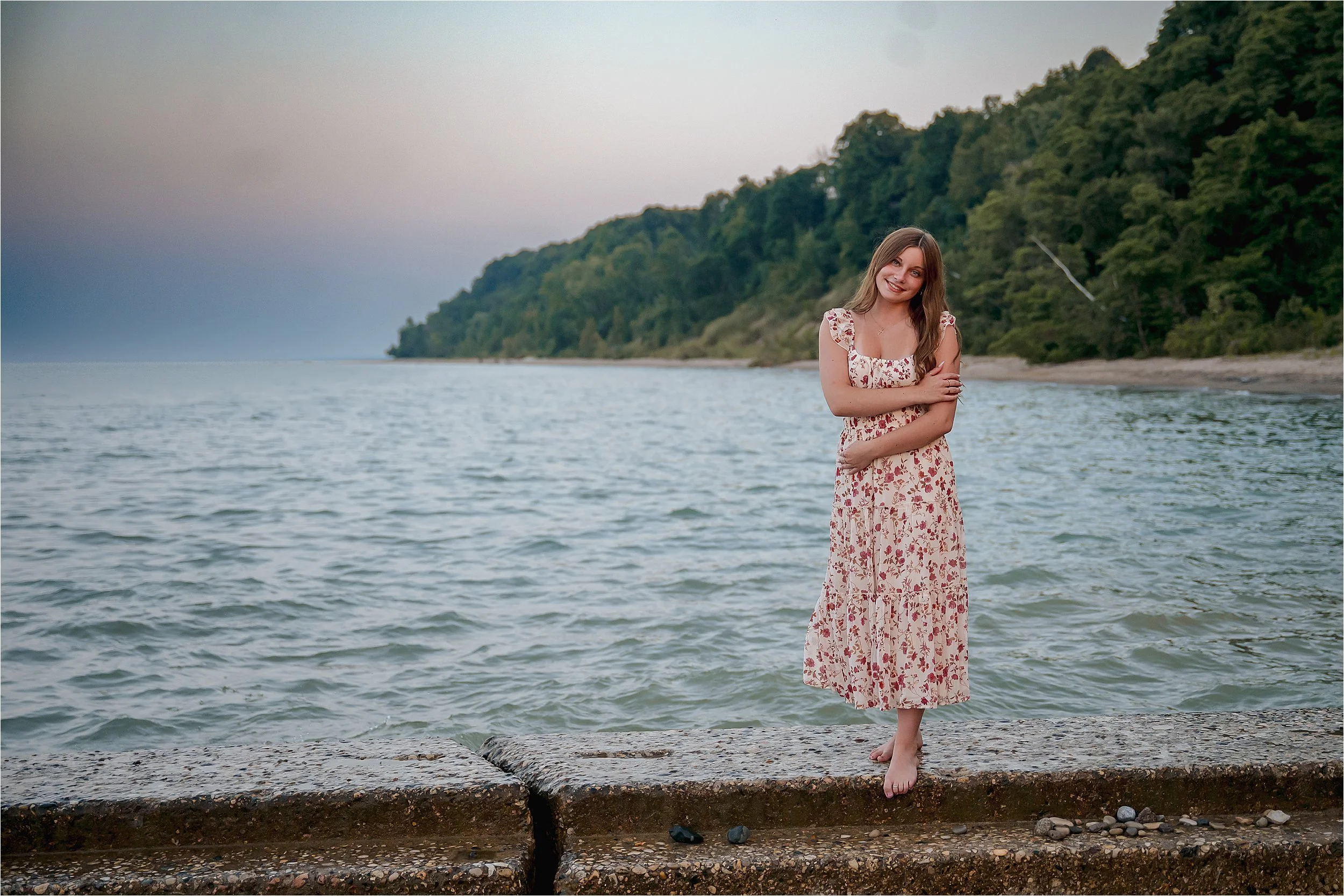Senior standing along Lake Michigan shoreline during a Milwaukee lakefront senior picture session at grant park seven bridges