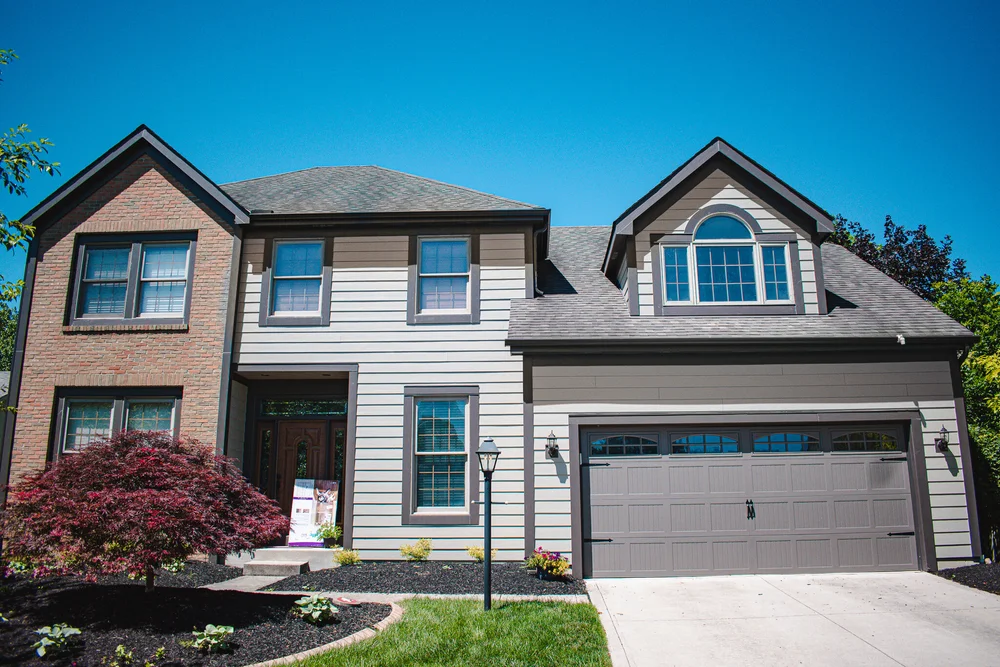 Two-story home with finished siding and gray garage door in Hilliard, Ohio