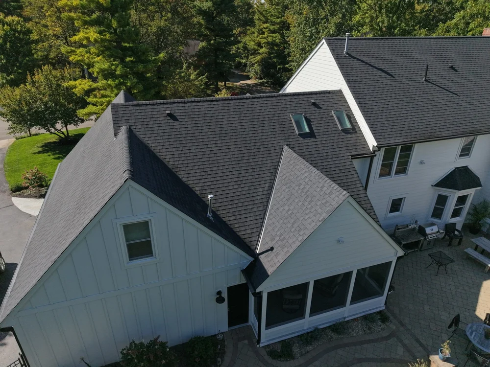 New dark architectural shingle roof on a two-story gray home, completed by RoofNut in Columbus, Ohio
