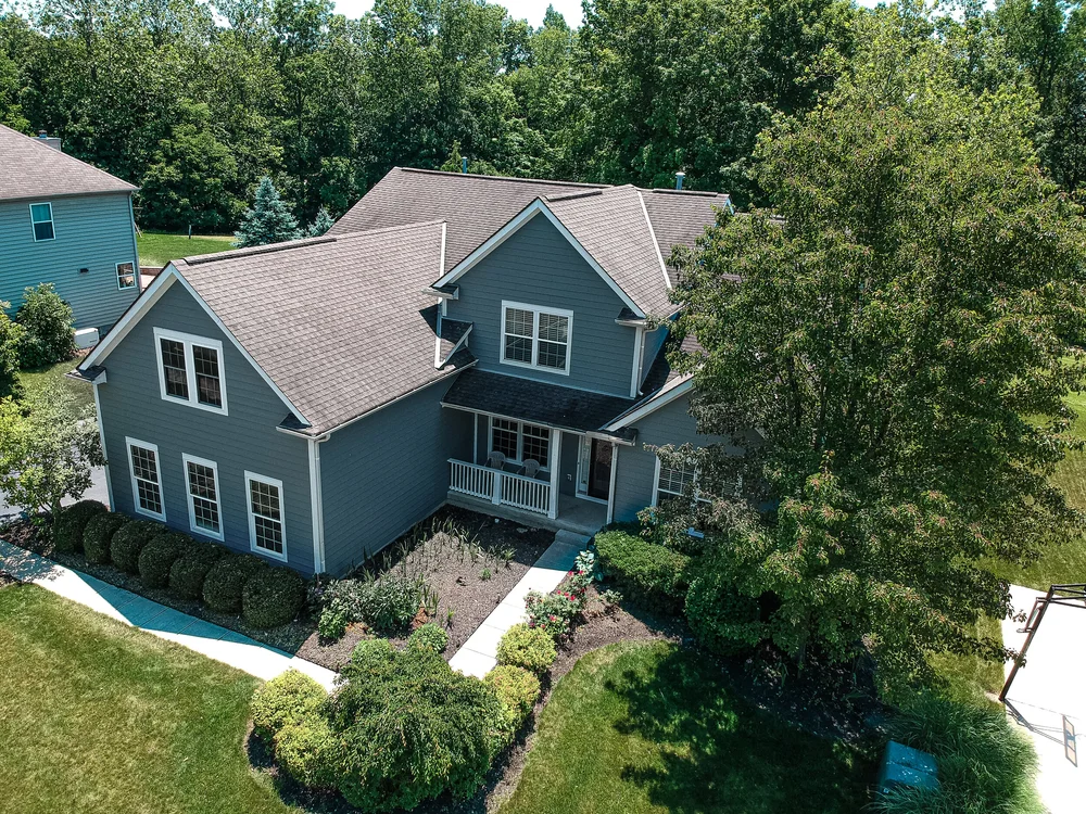 Aerial view of a gray-green sided home with new roof in Columbus, Ohio
