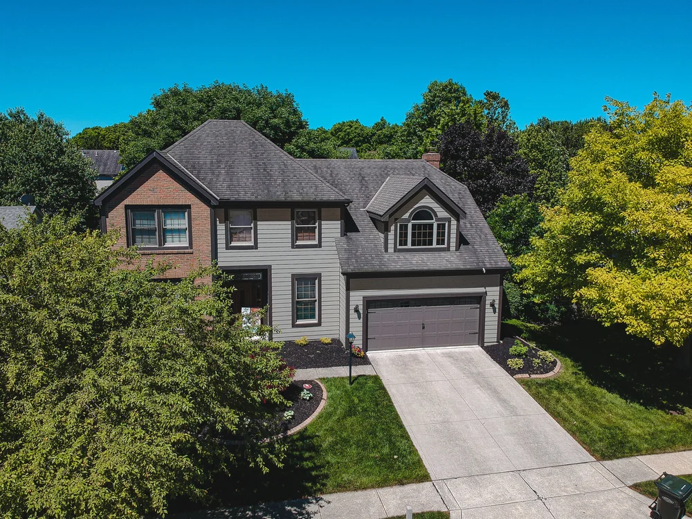 Front view of a two-story home with new siding and gray garage door, Columbus, Ohio