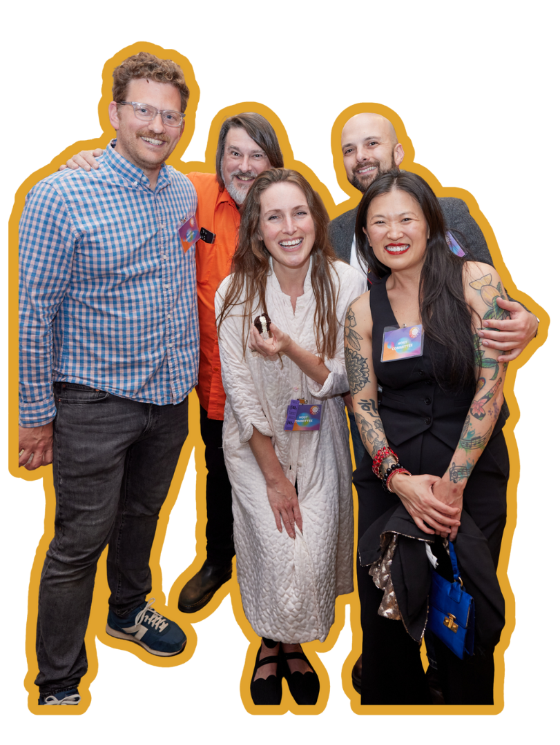 Four people standing together smiling